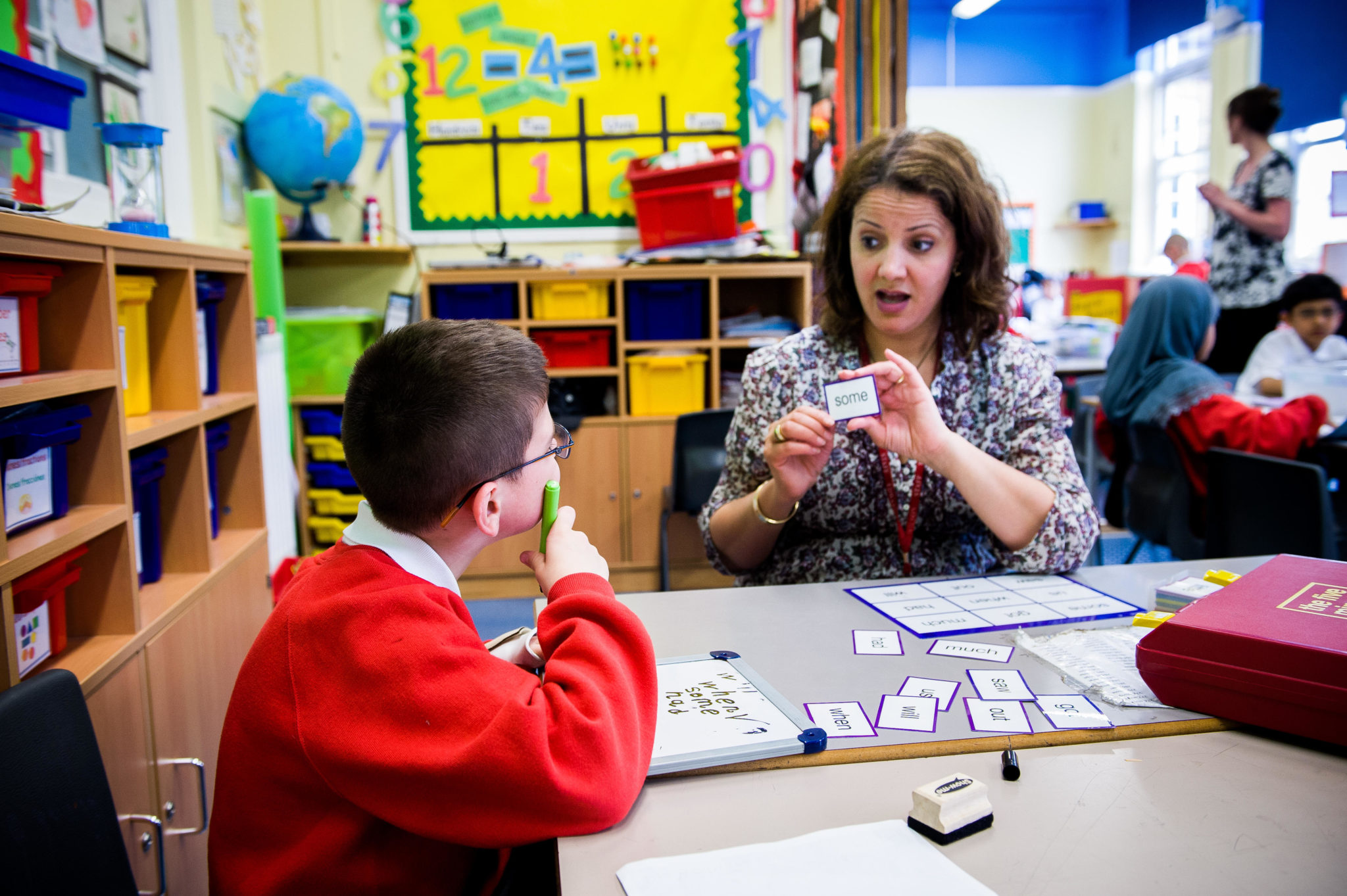 roger askFile photo of a learning support worker with a child with special needs in a London classroom. 