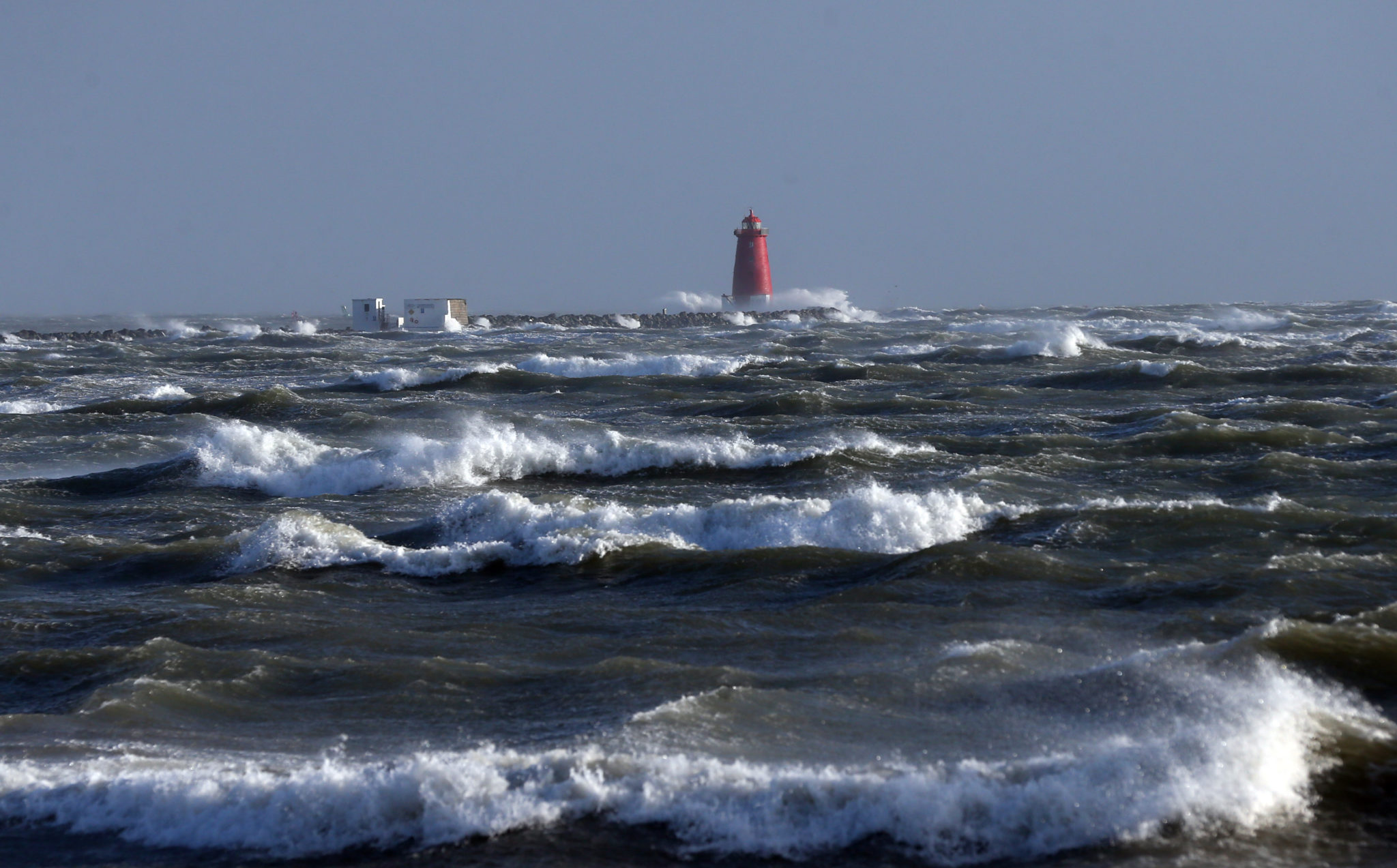 The Poolbeg lighthouse in Dublin is hit by rough waves