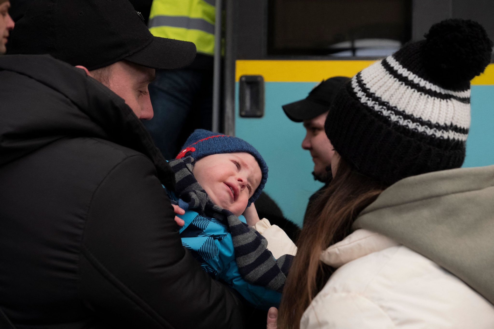 A Ukrainian father holds his child at a train station in the westernmost city of Lviv, near the Ukrainian-Polish border, to escape the ongoing Russian military conflict on March 1st 2022