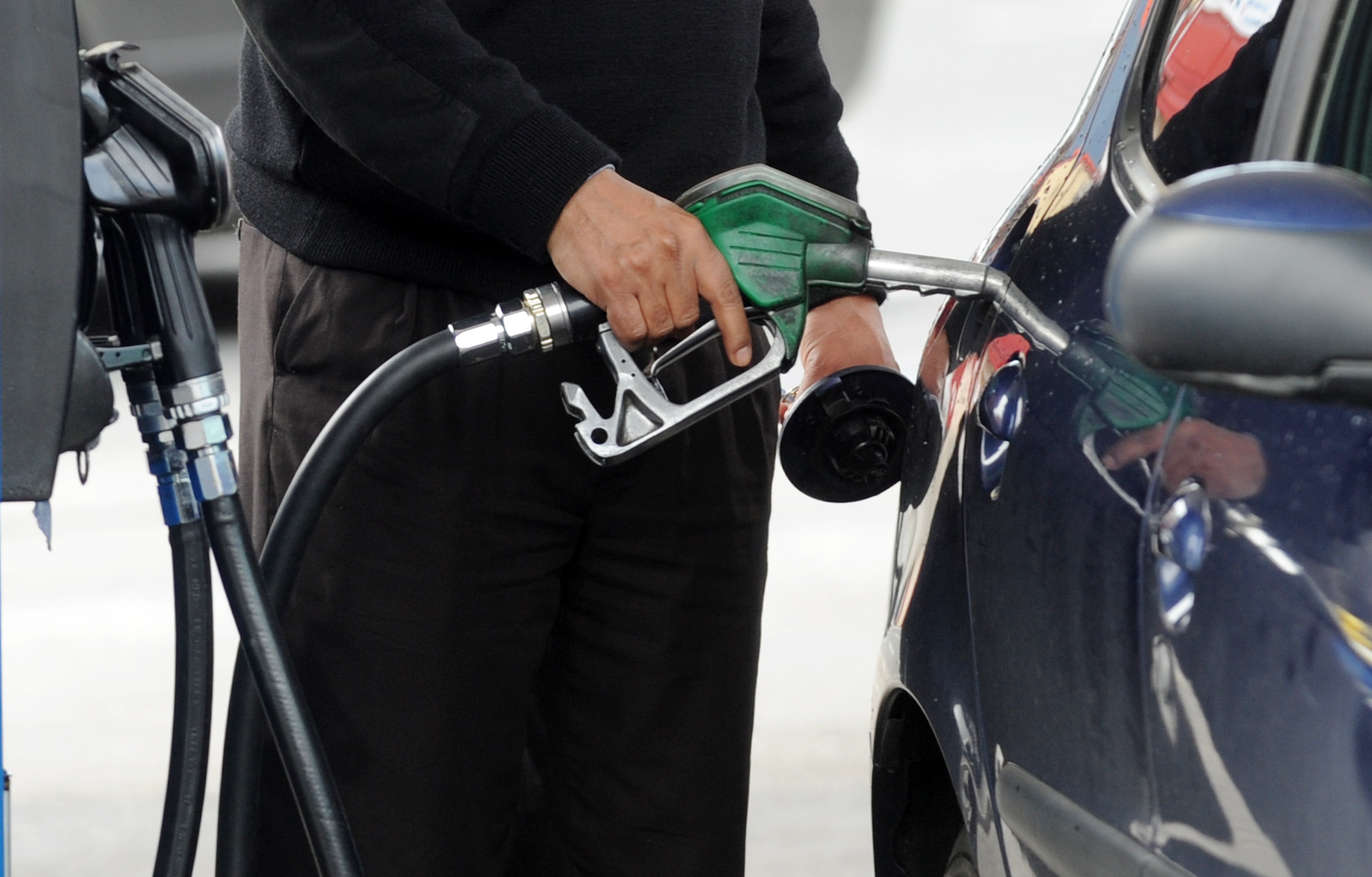 A man puts petrol into his car in April 2012