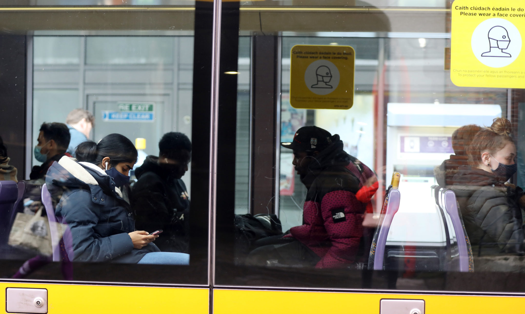 Passengers with and without face masks sitting on a Luas tram at the Red Line at Jervis Street Dublin, 28-02-2022. Image: Leah Farrell/RollingNews