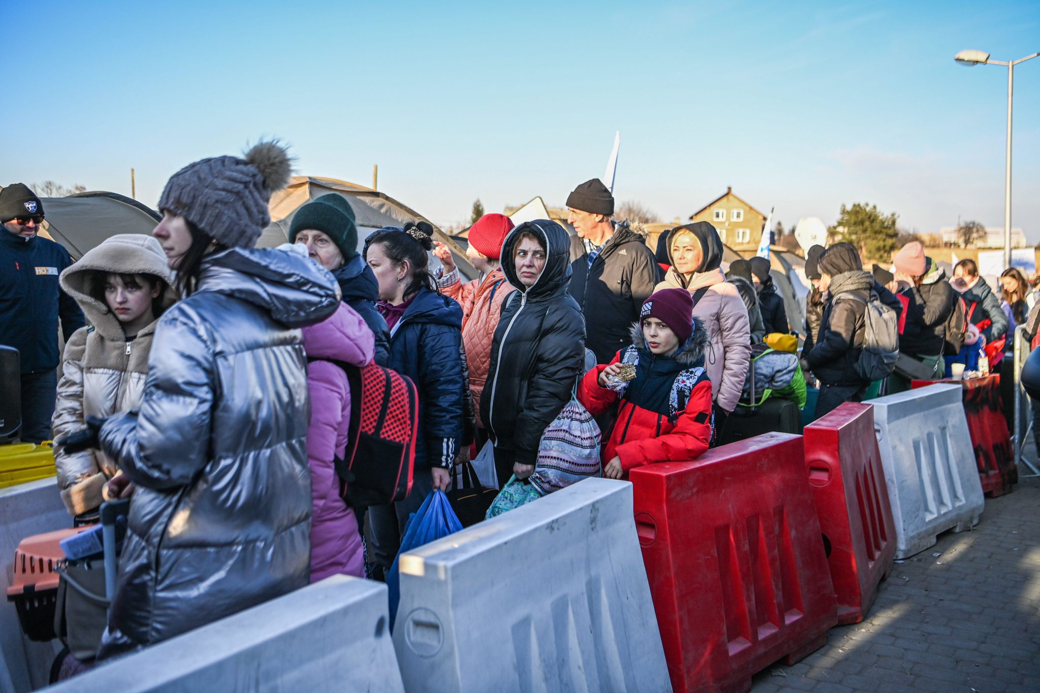 Ukrainian refugees wait to board busses at the Medyka border crossing in Poland on March 11th, 2022.