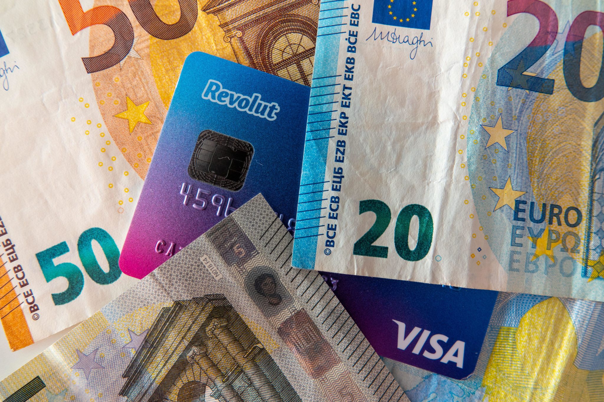 A Revolut Visa credit card and paper Euro money