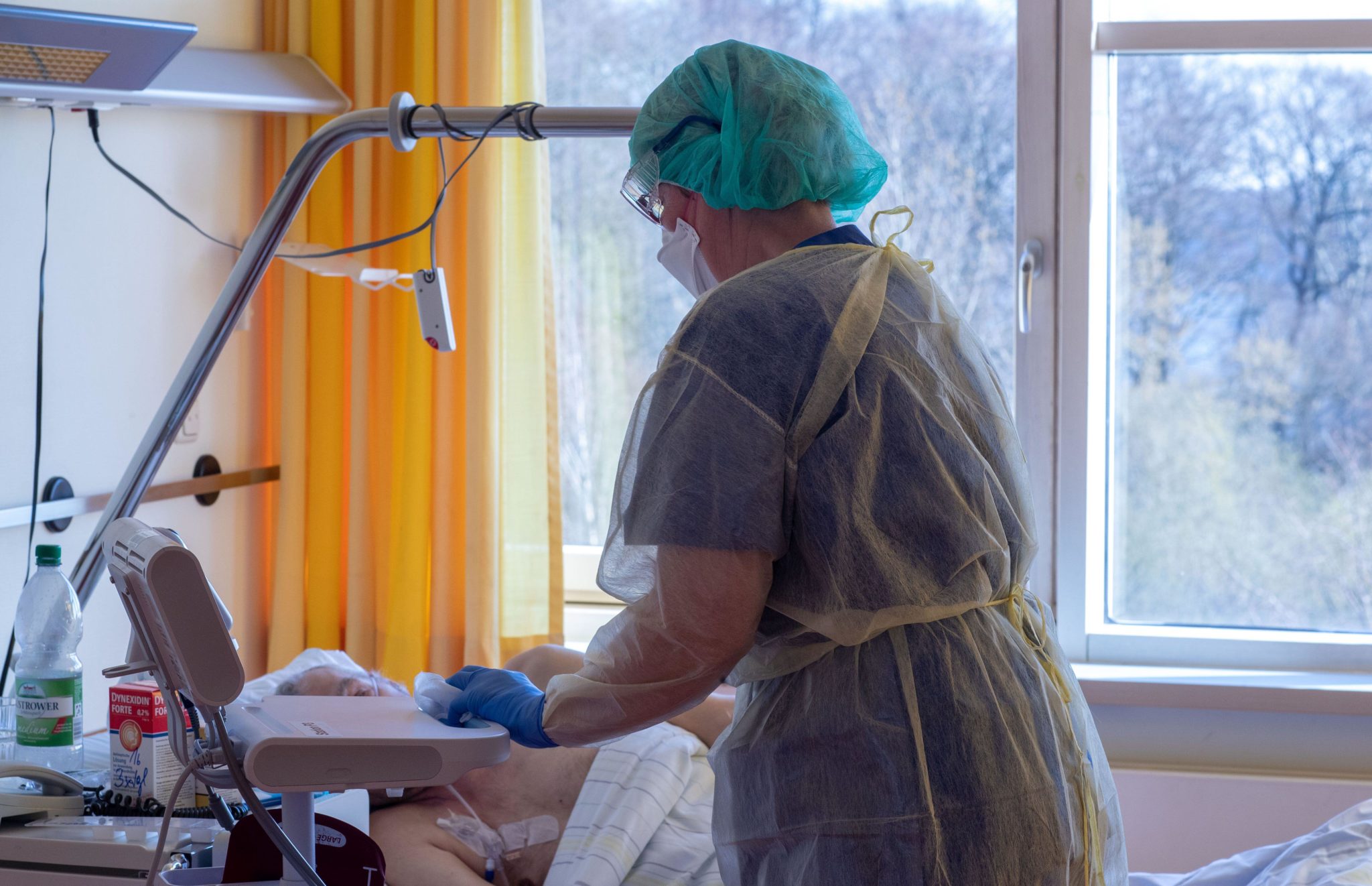 A nurse talks to a patient in the isolation ward for coronavirus treatments in a hospital in Schwerin, Germany in March 2020.