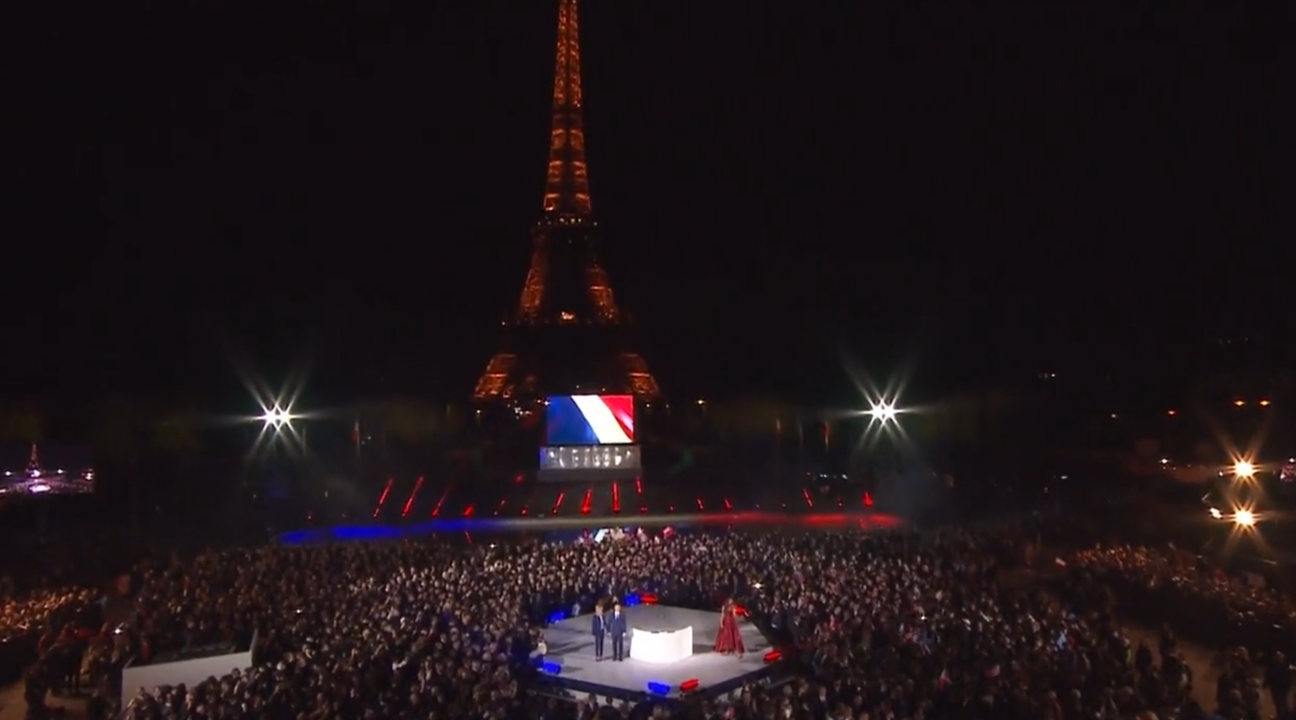 Crowds gather at the Eiffel Tower in Paris, as Emmanuel Macron claimed victory on Sunday. 