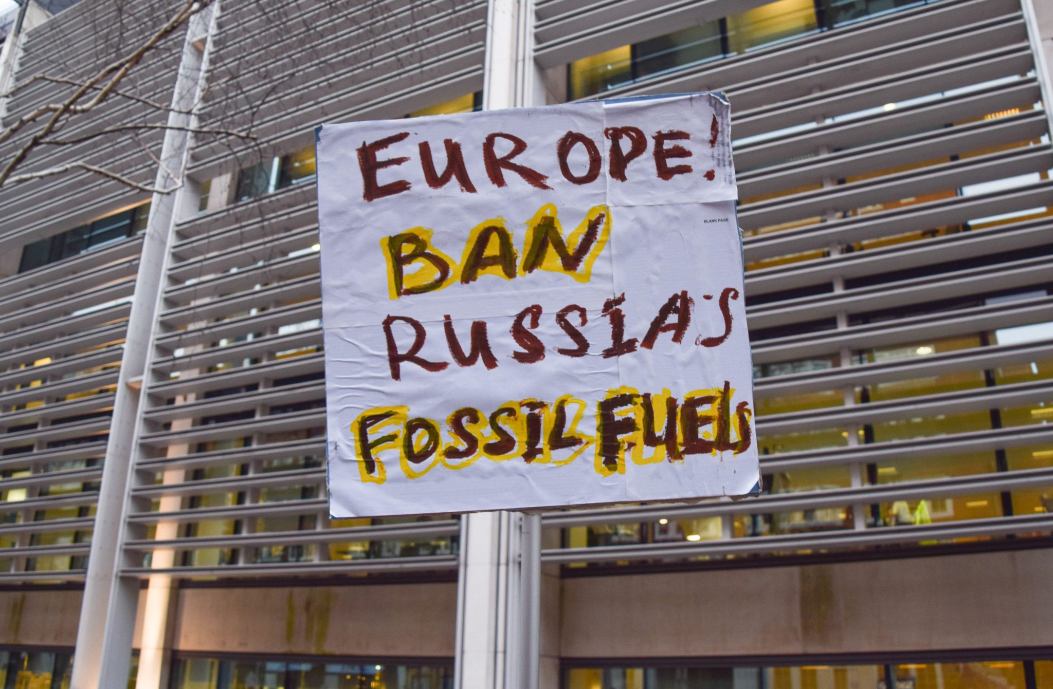 A protest sign calls for a ban on Russia's fossil fuels in London, England in March 2022