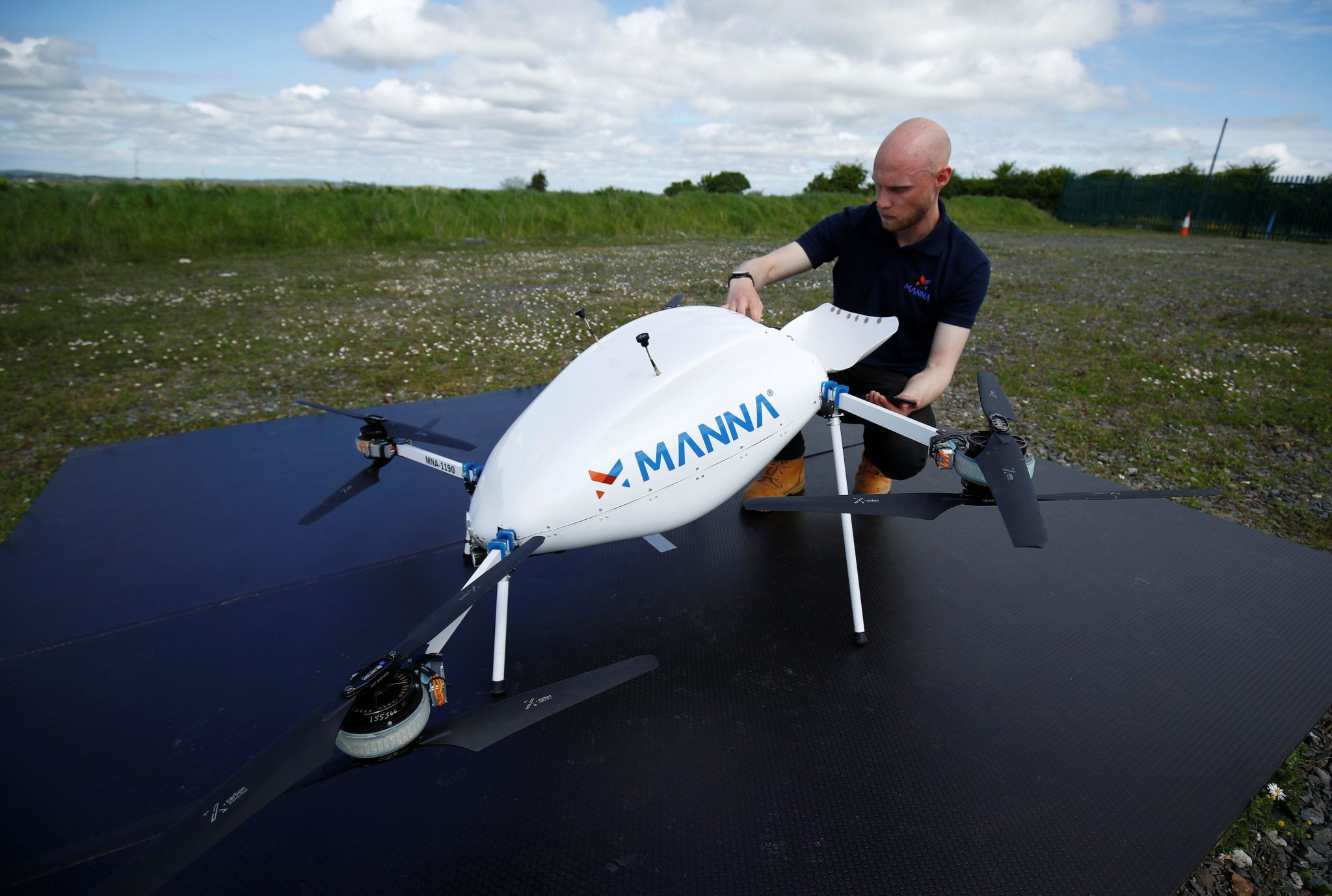 A Manna Aero drone operator loads up essential household and medical supplies for delivery. Image:  REUTERS / Alamy Stock Photo