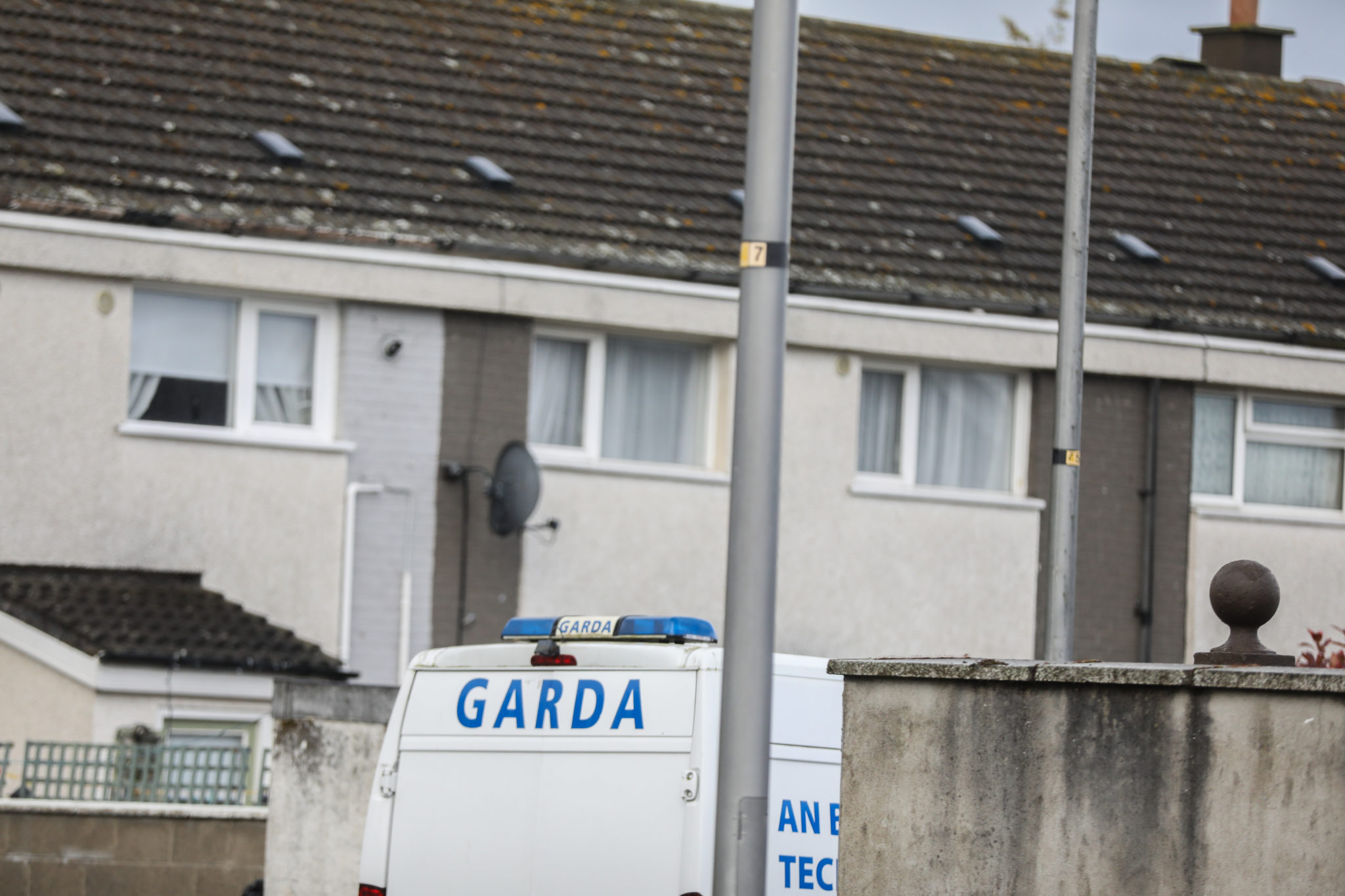 A Garda van on the scene at Sandyhill Gardens in Ballymun, Dublin where the body of a woman was found in her home.