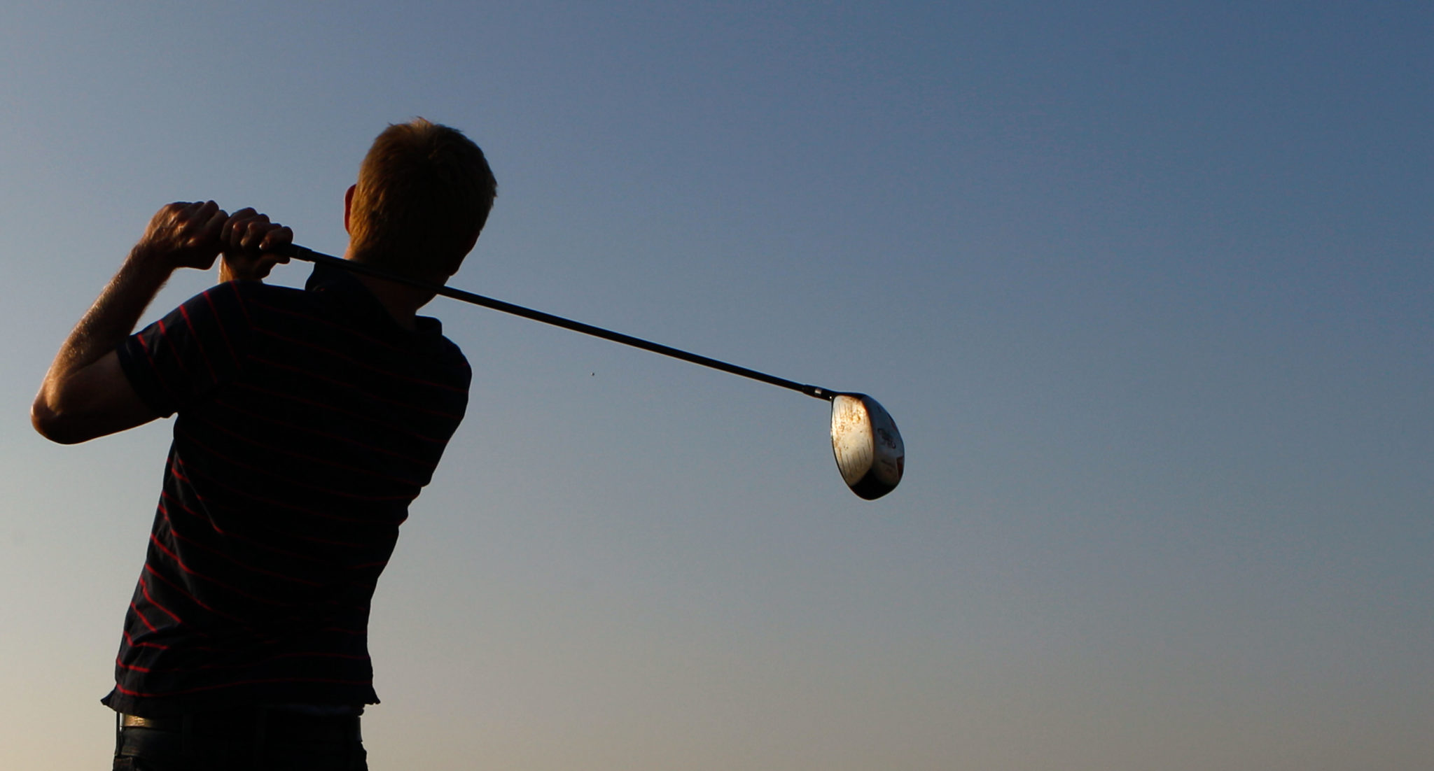A golfer swinging a club.