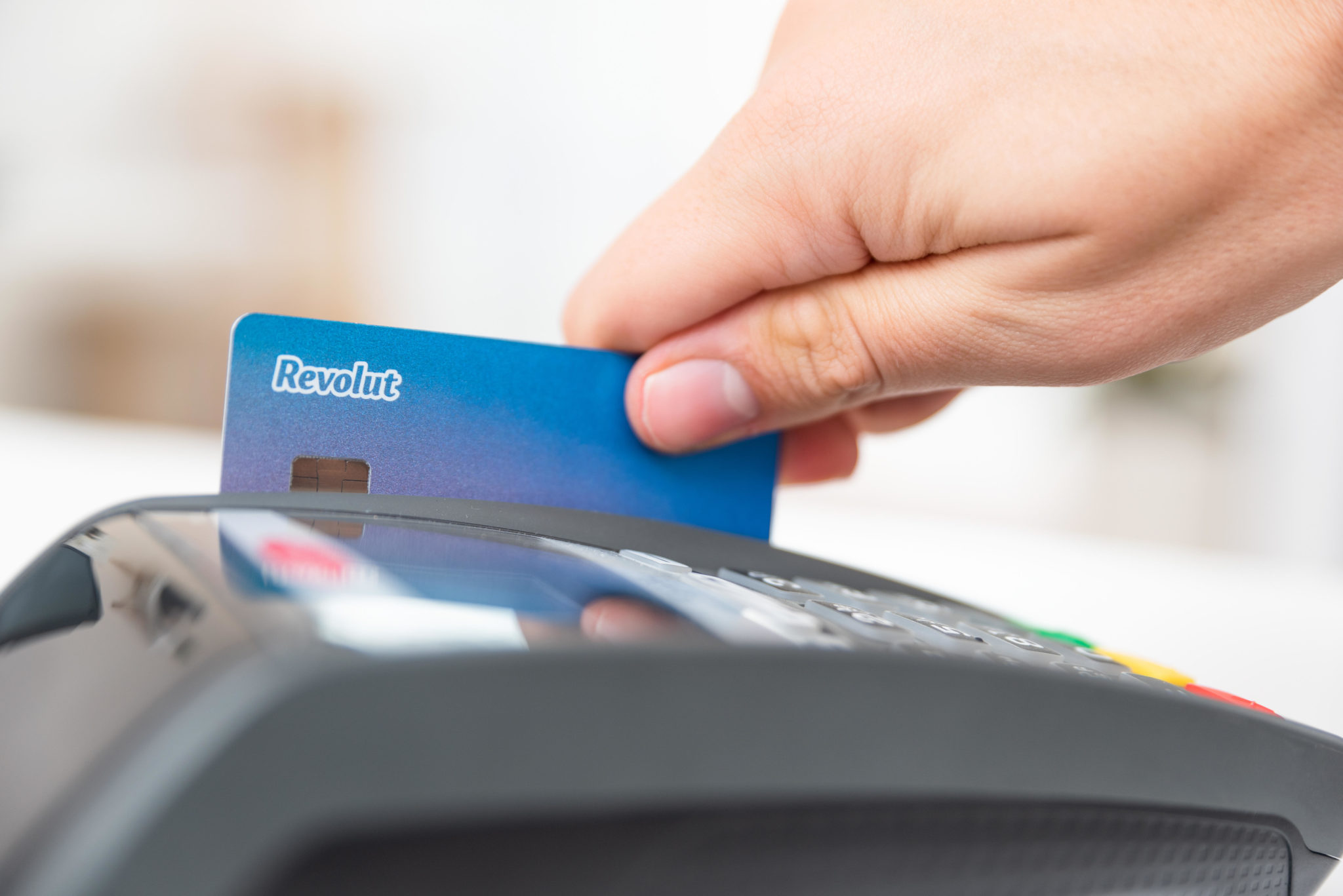 A person swipes a Revolut debit card in Poland in November 2019