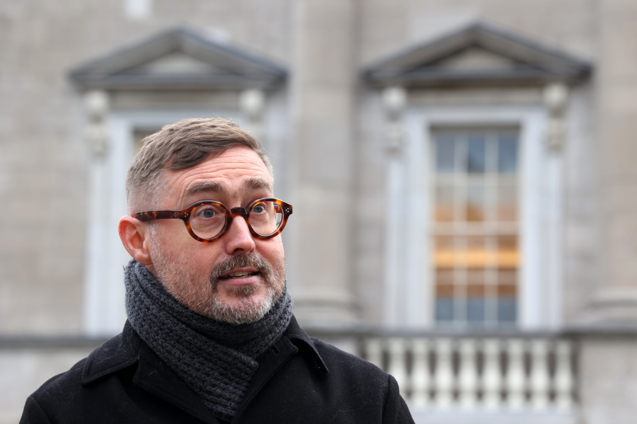 Sinn Fein spokesperson on housing Eoin O Broin on the plinth outside Leinster House in January 2022