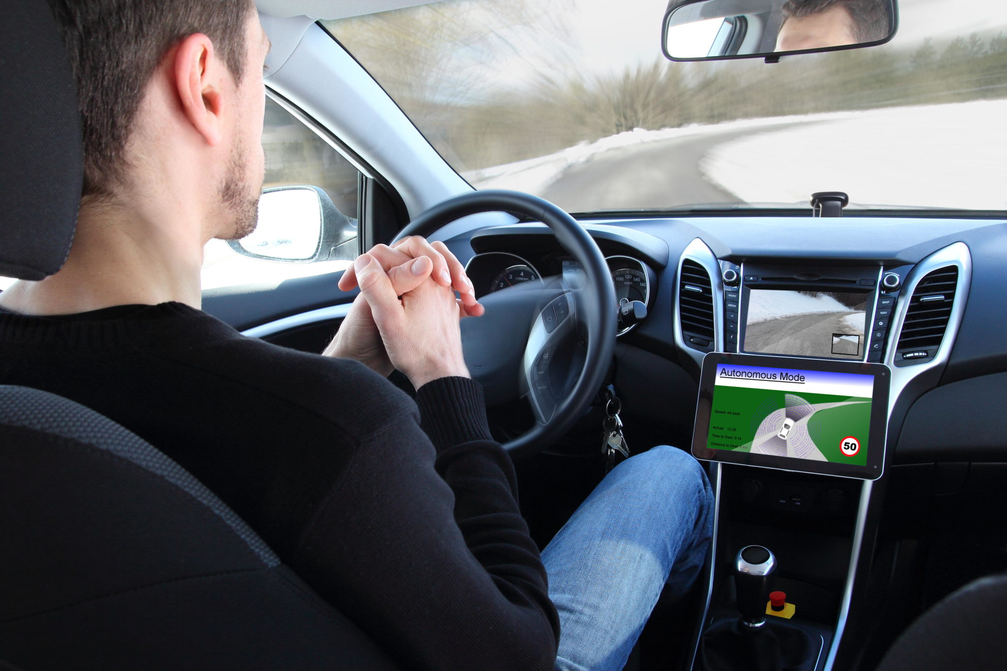 A man in an autonomous driving test vehicle in January 2015.