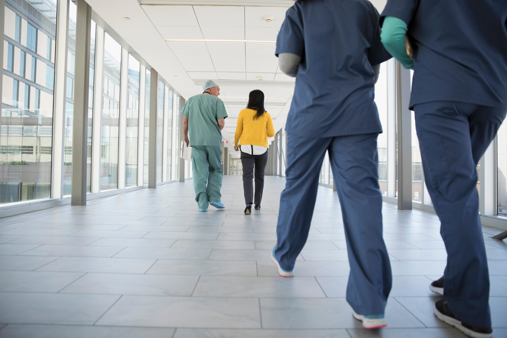 A surgeon, doctor and nurses walking in a hospital corridor in October 2017.