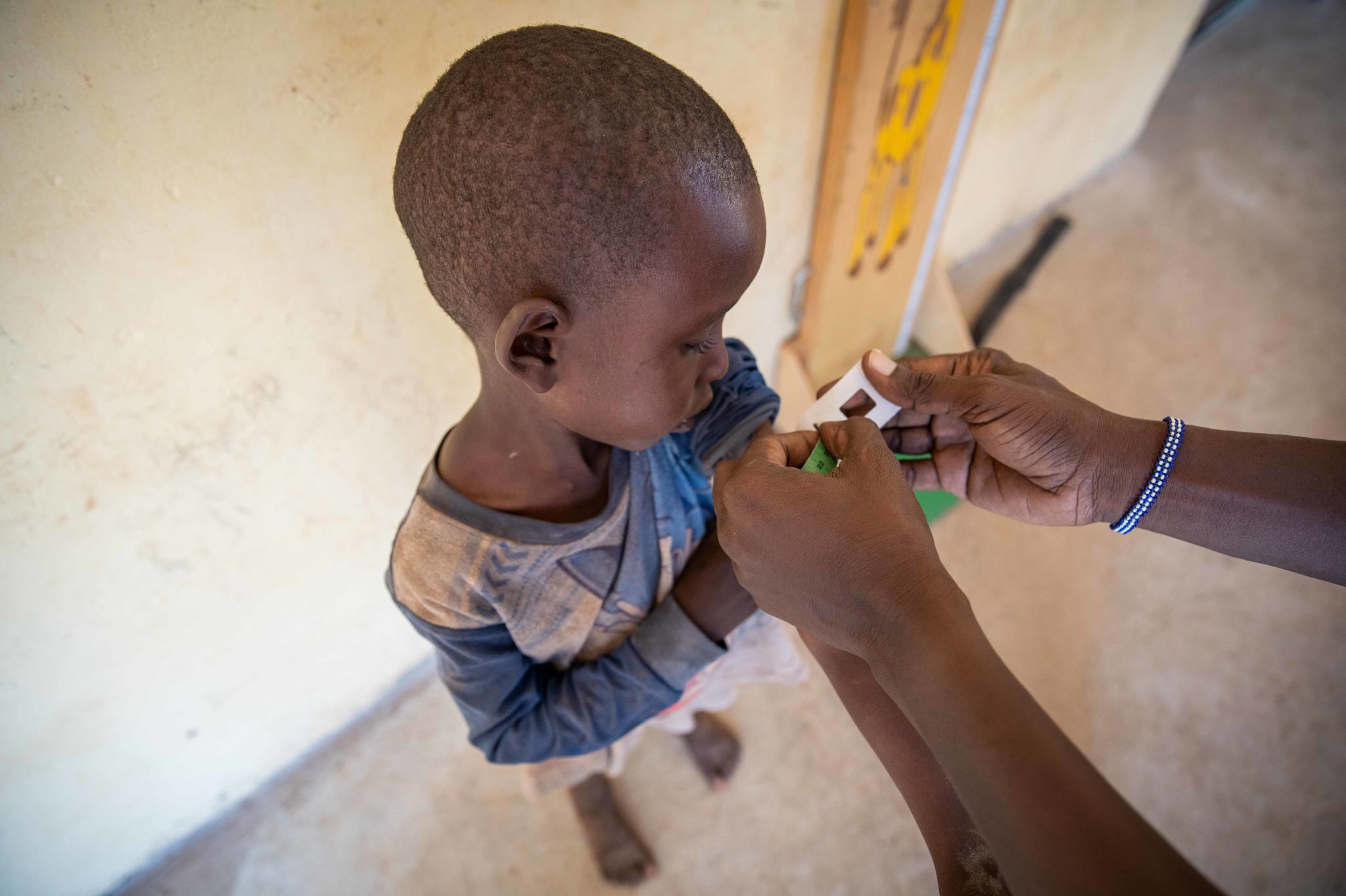 Engoit Lokidor’s 4-year-old son, Maraka, is measured at a malnutrition clinic in Lekwasimyen in Northern Kenya's Turkana province on 28th June 2022