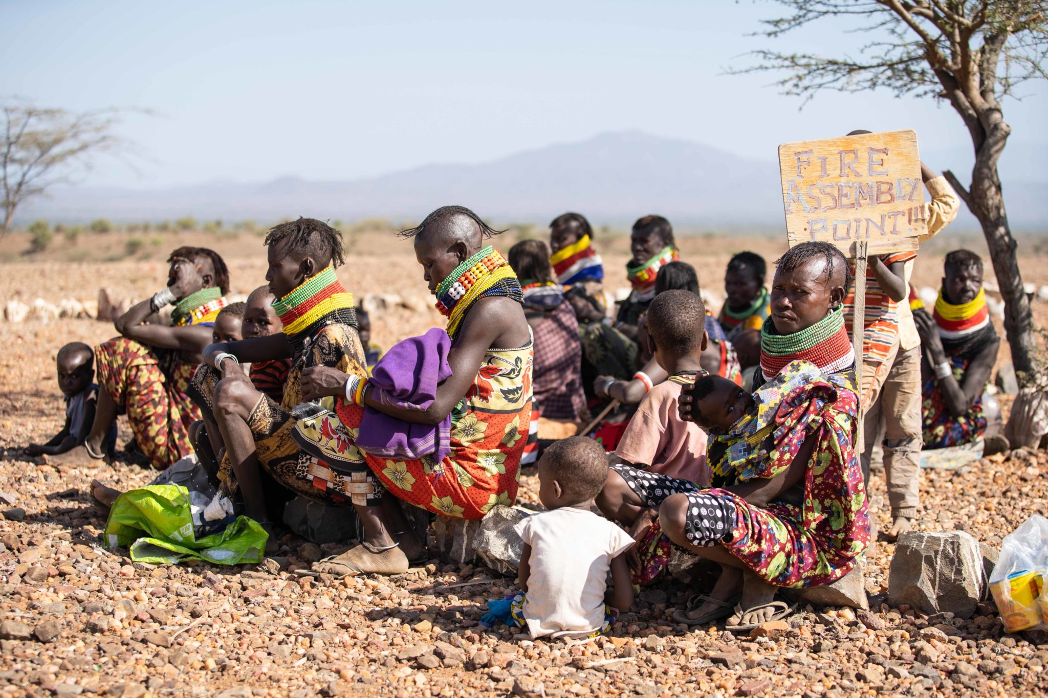 Women wait for their children to receive treatment for malnutrition in Lekwasimyen in Northern Kenya's Turkana province on 28th June 2022