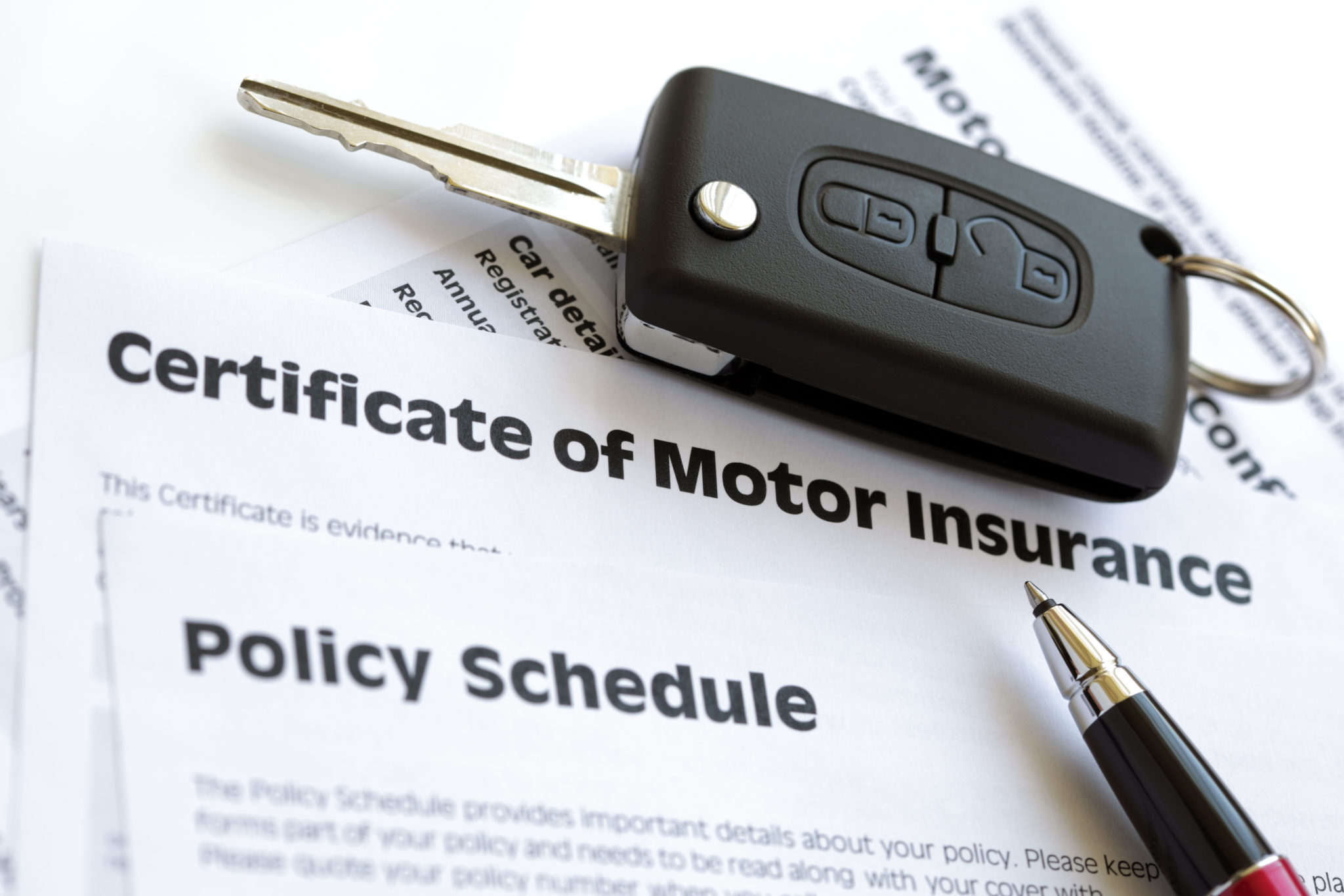 A motor insurance certificate with a car key in August 2011.