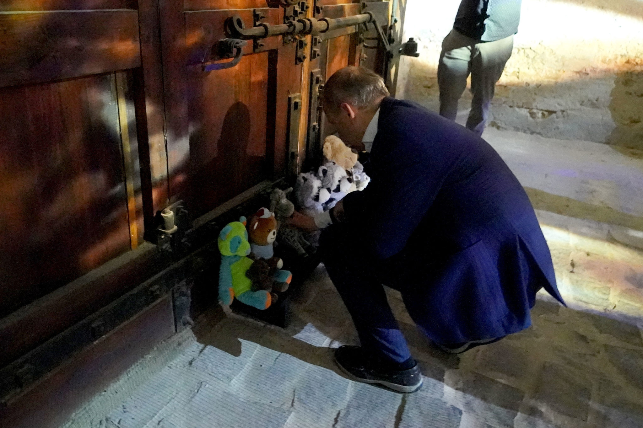 Taoiseach Micheal Martin places a soft toy at the memorial to children killed during the Russian invasion in Kyiv, 06-07-2022. Image: Niall Carson/PA Wire