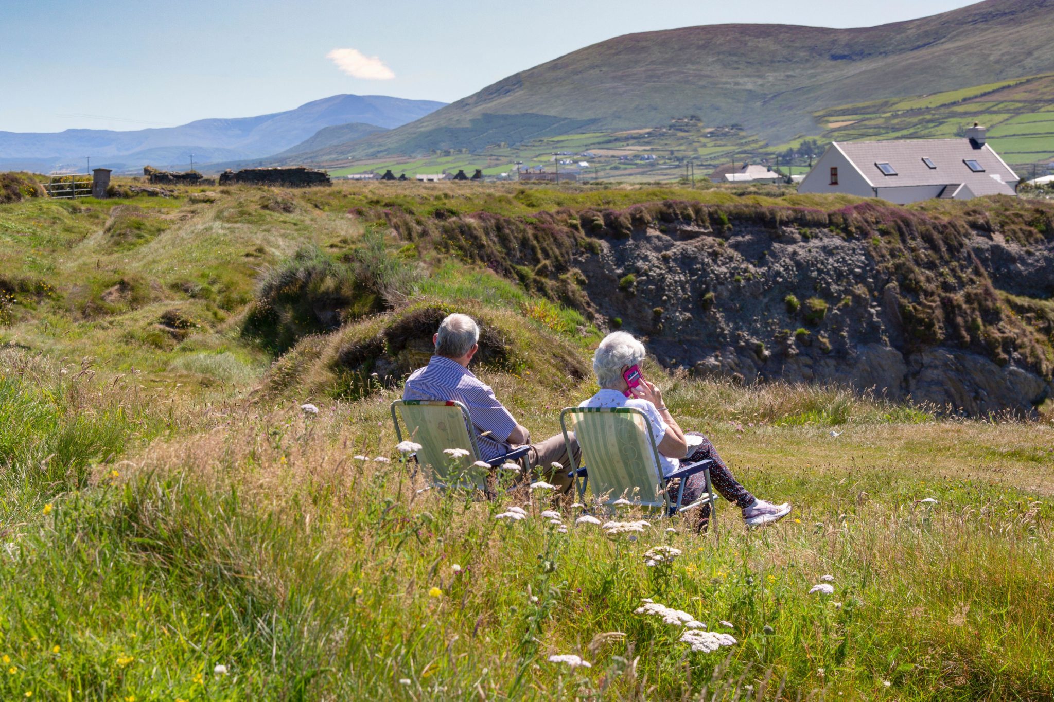 A couple sitting on garden chairs on Valentia Island, Kerry, 13-07-2022.