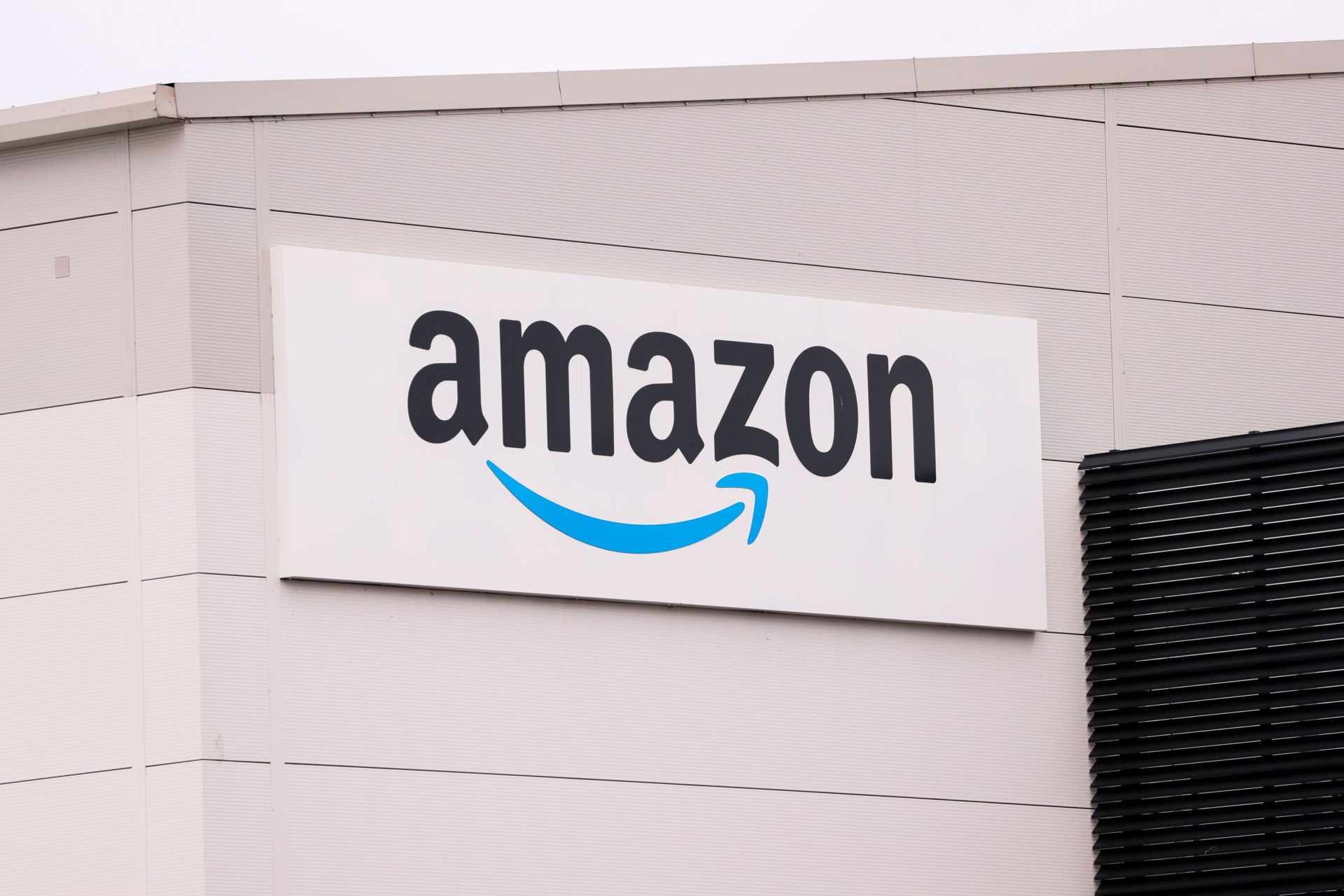 An Amazon logo and signage at a delivery hub in Belfast, Northern Ireland.