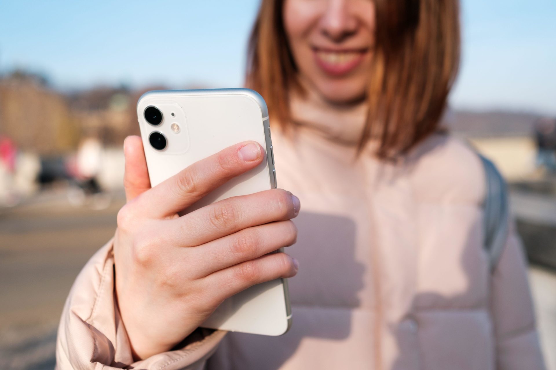 A woman recording a video on her smartphone
