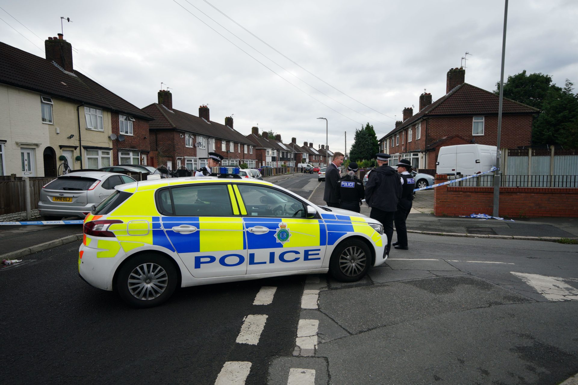 Police at the scene in Knotty Ash, Liverpool, where a nine-year-old girl has been shot dead.