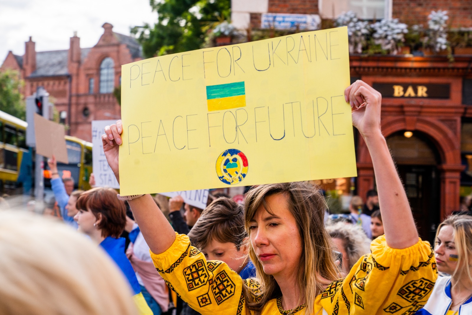People hold signs to mark Ukraine Independence Day in Dublin city.