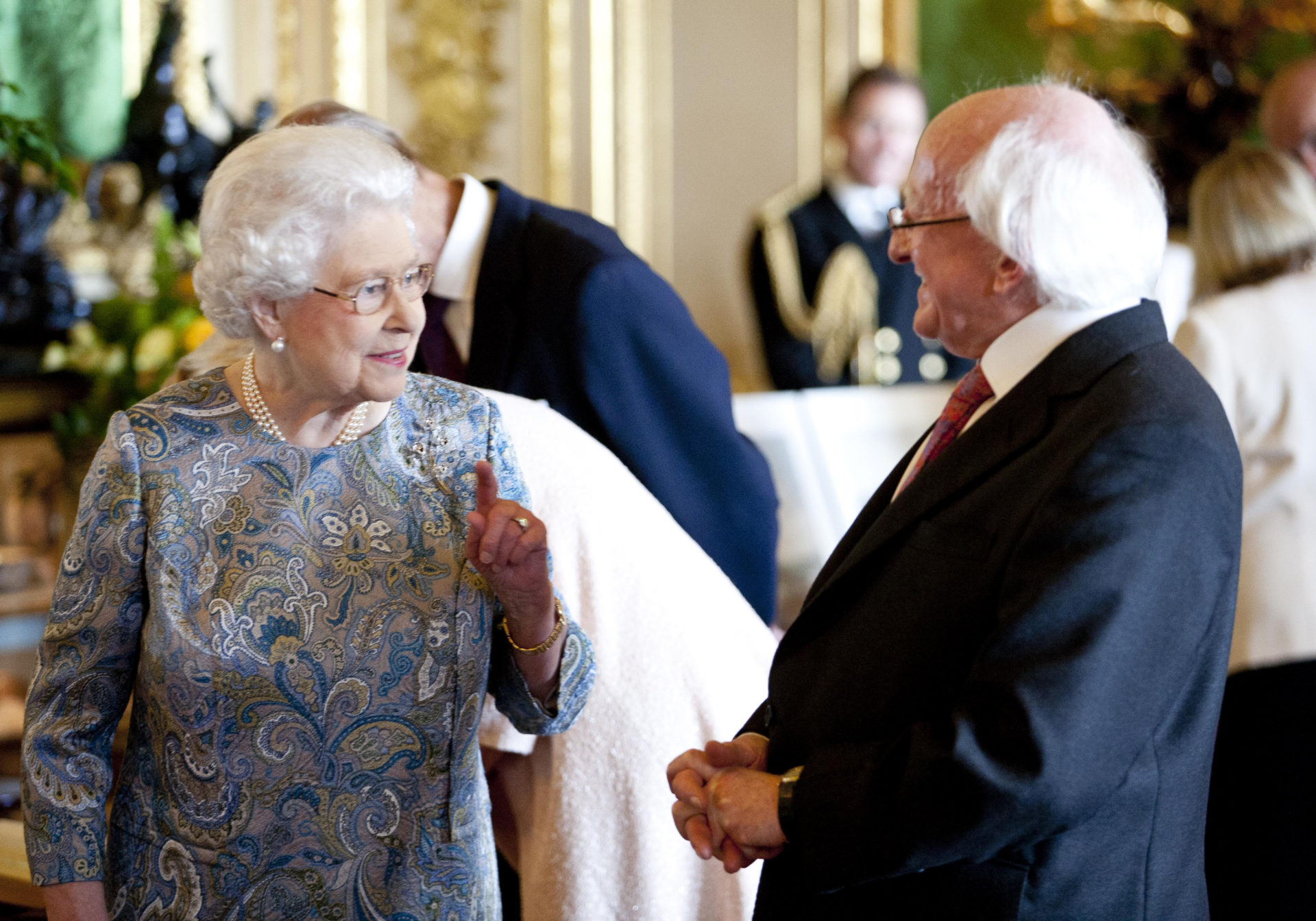 President Michael D Higgins with Britain's Queen Elizabeth II viewing a display of Irish items from the Royal Collection in the Green Drawing Room at Windsor Castle during a visit in April 2014