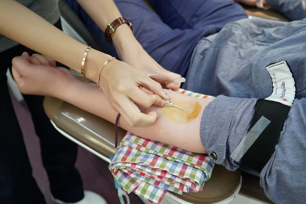 Blood. Image shows a blood donation procedure under way.