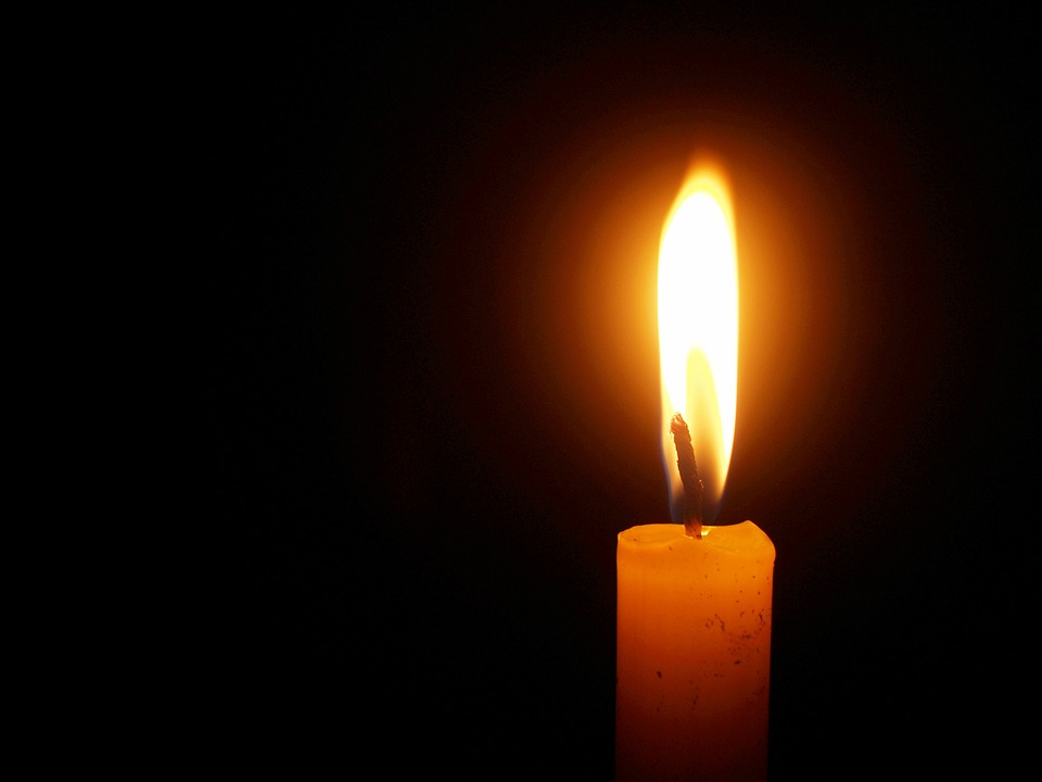 Westmeath. Image shows a single lighted candle against a dark background.