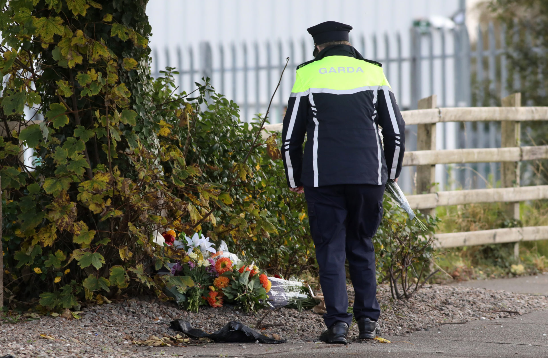 A Garda leaves flowers at the scene of the explosion.