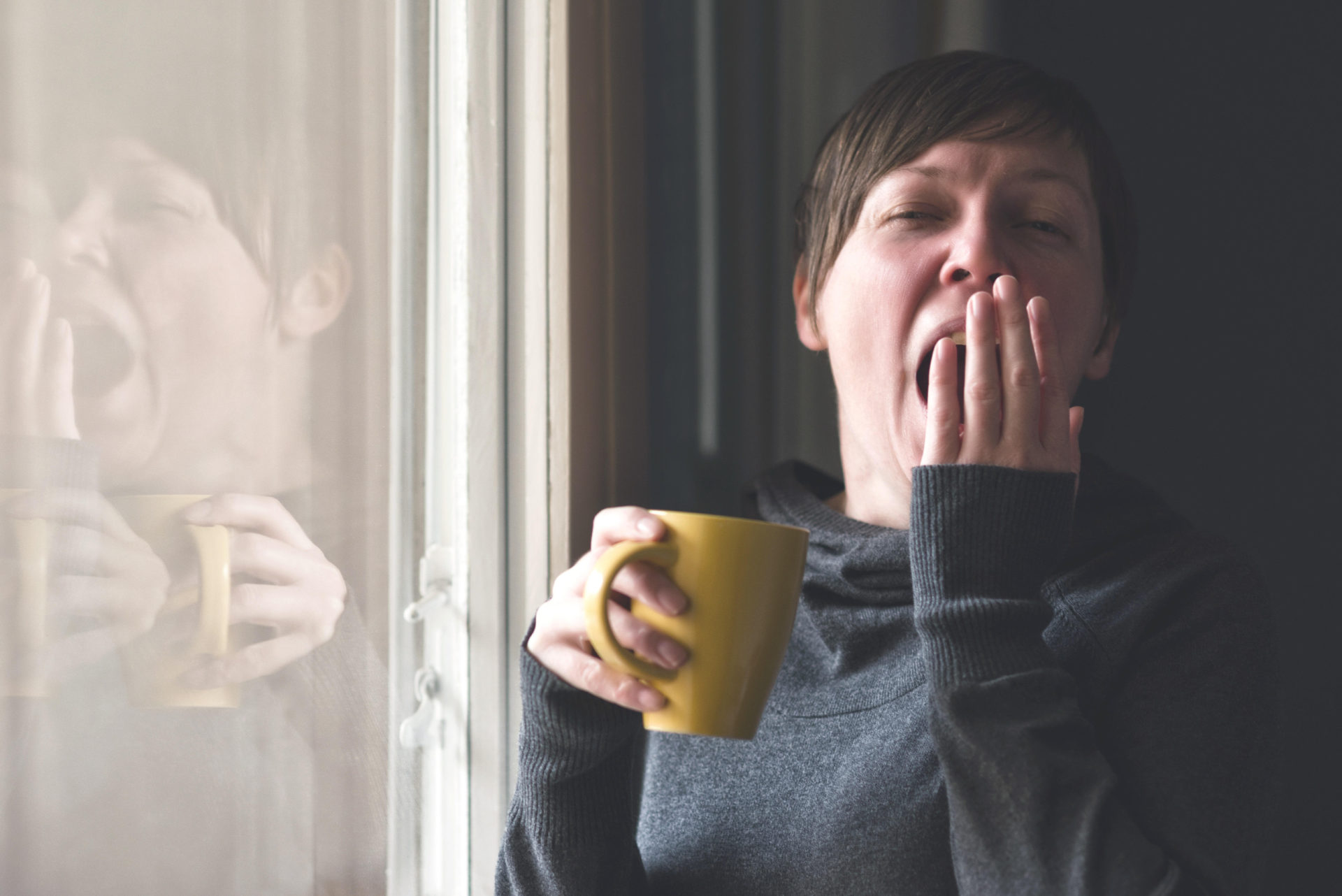 A yawning woman. Igor Stevanovic / Alamy