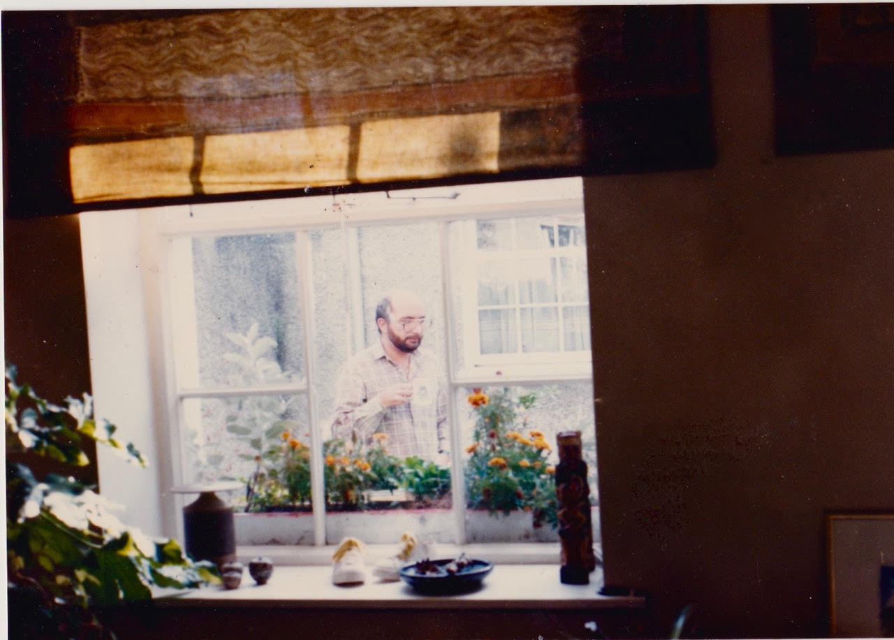 Charles Self seen through a window.