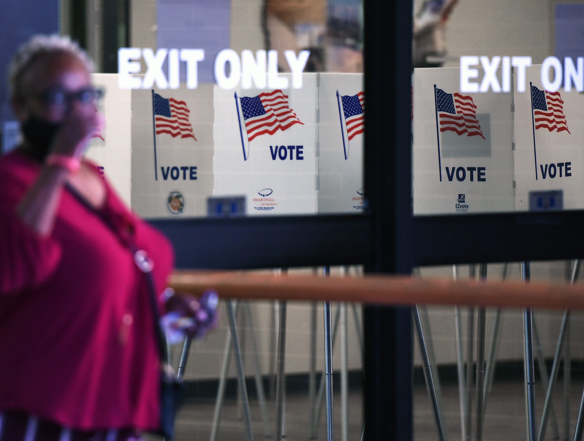 A woman leaves the Orange County Supervisor of Elections Office on the first day of early voting in the 2022 US midterm elections in Orlando