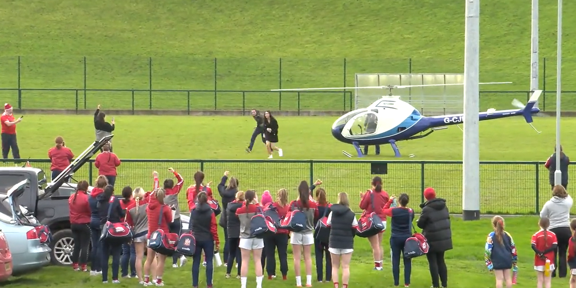Teammates greet Cathriona as she disembarks the helicopter