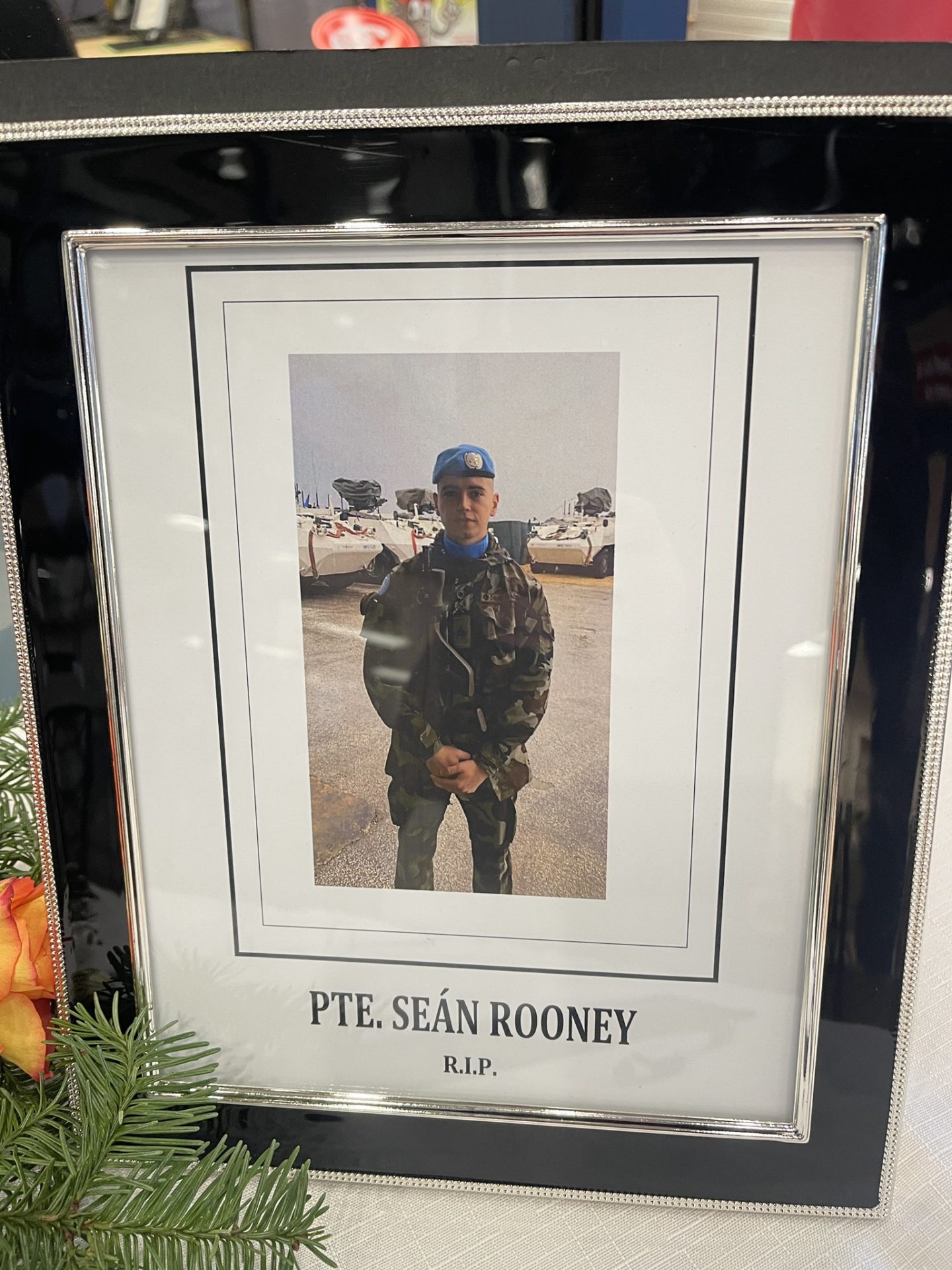 A photo of Private Seán Rooney beside a book of condolence in Co Louth