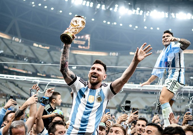 Lionel Messi celebrates with the World Cup trophy in Qatar. Image: FIFA