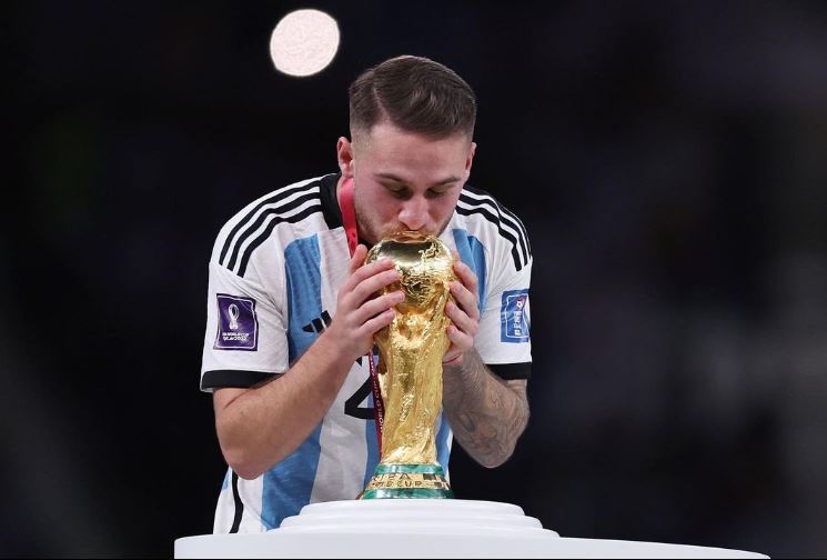 Alexis Mac Allister kisses the World Cup trophy after Argentina's win