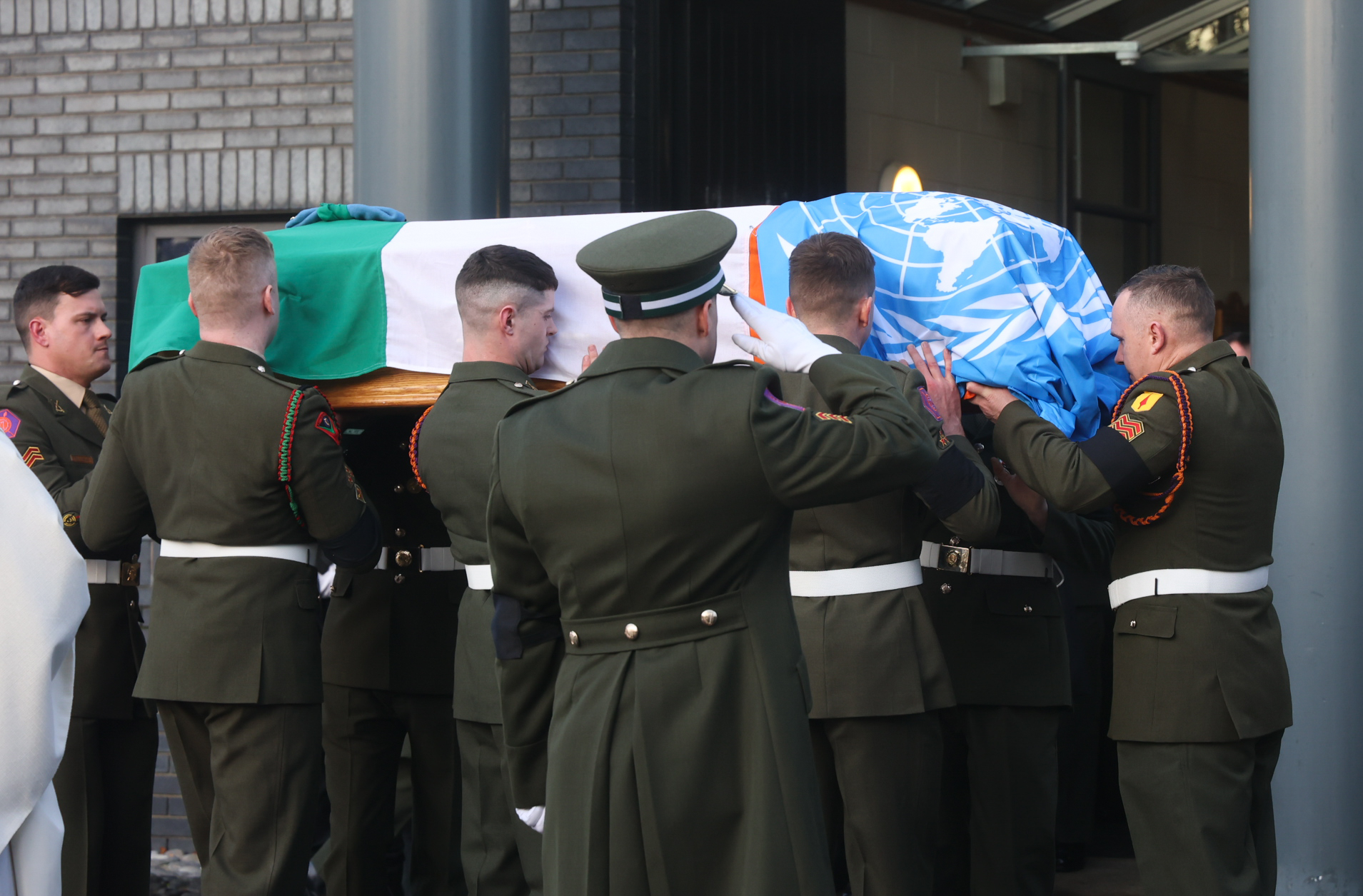 A Defence Forces guard accompanies the coffin of Pte Seán Rooney as it is carried from the Holy Family Church in Dundalk, 22-12-2022. Image: Sam Boal / RollingNews