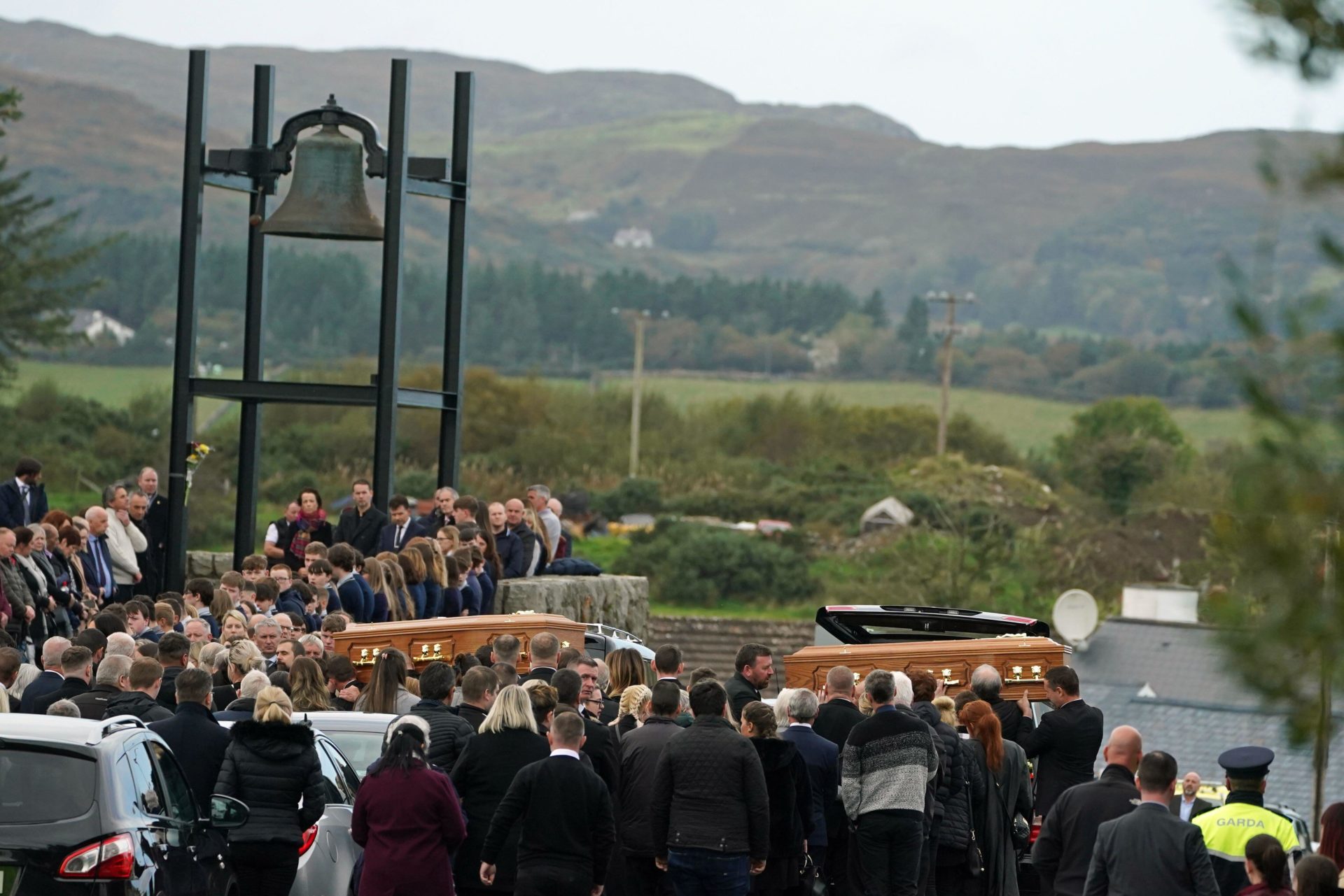 The coffins of James Monaghan and his mother Catherine O'Donnell are carried into St Michael's Church, Creeslough for their funeral mass. 