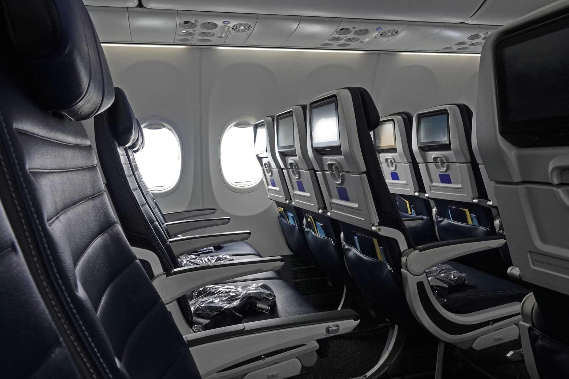 Empty rows of seats in economy class of a commercial airliner in June 2022
