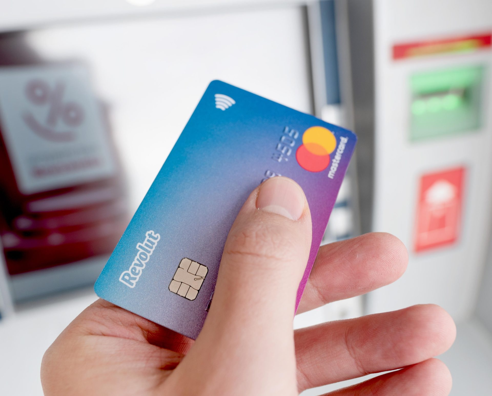 A Revolut debit card is seen with an ATM in the background in November 2019.