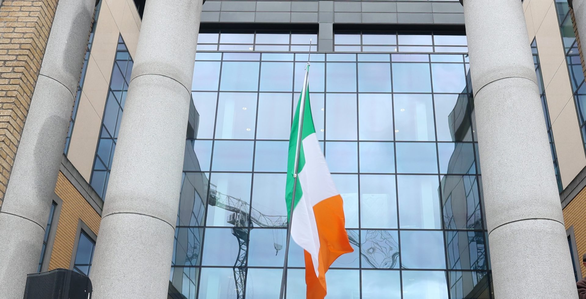 A crowd of people with an Irish Tricolour gathered outside the former ESB offices on East Wall Road in Dublin in November 2022.