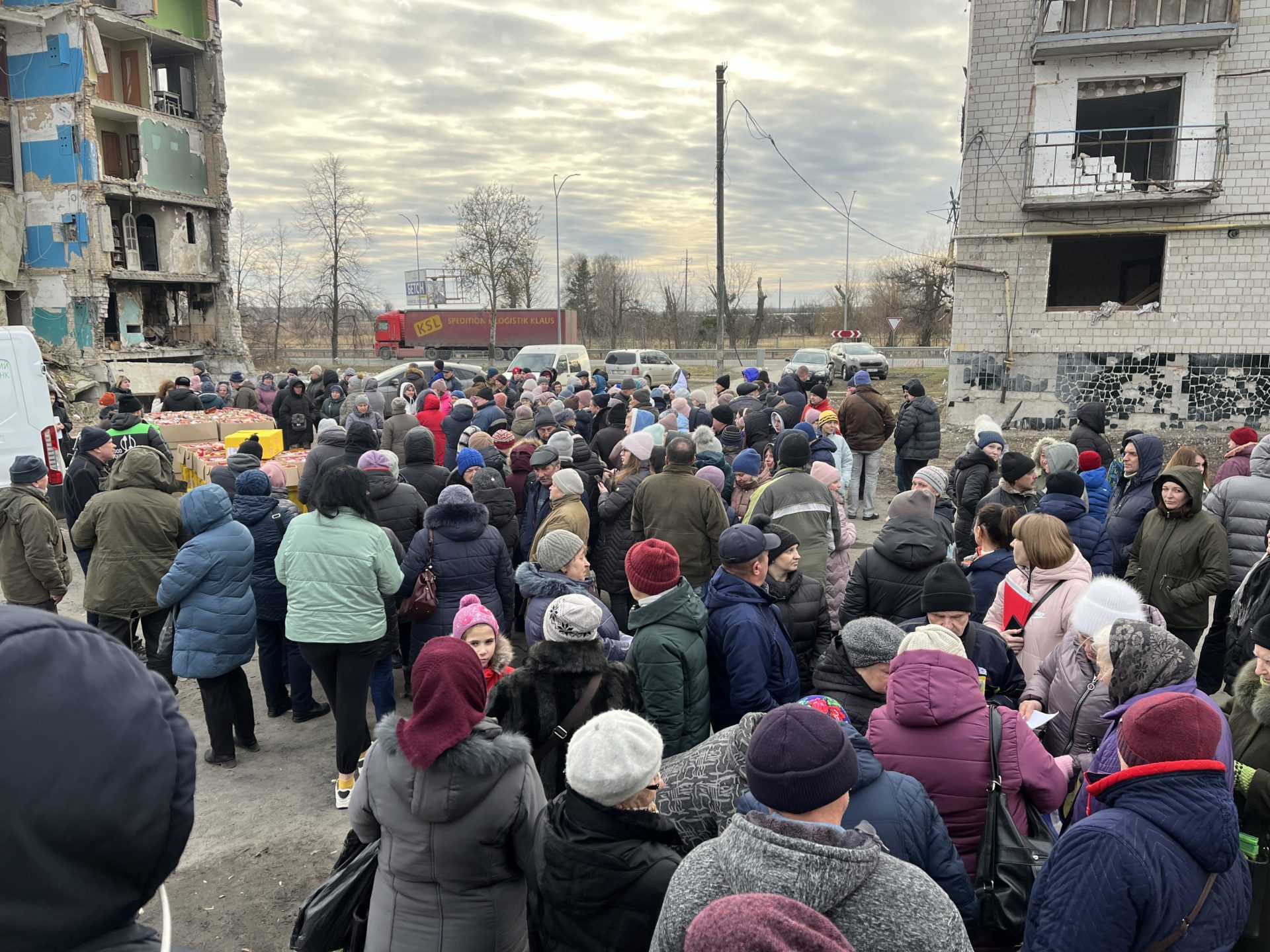 Locals queue for food in a bombed-out area near Kyiv