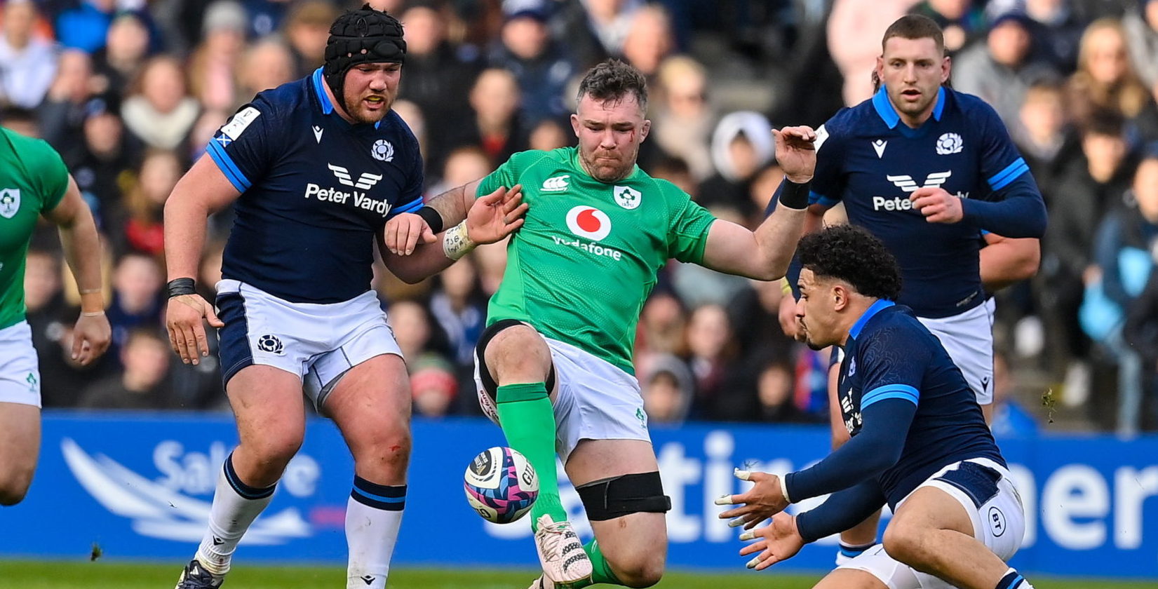 Peter O’Mahony of Ireland kicks the ball down-field despite the attempts of Sione Tuipolutu of Scotland during the Guinness Six Nations Rugby Championship match between Scotland and Ireland. 