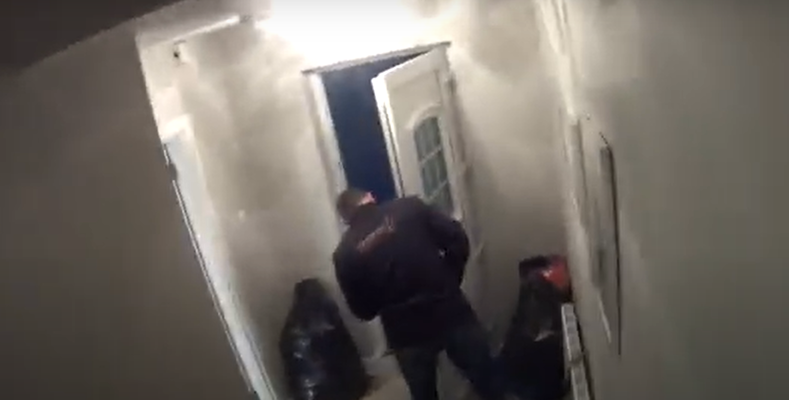 A still from the video footage shows a man changing the locks