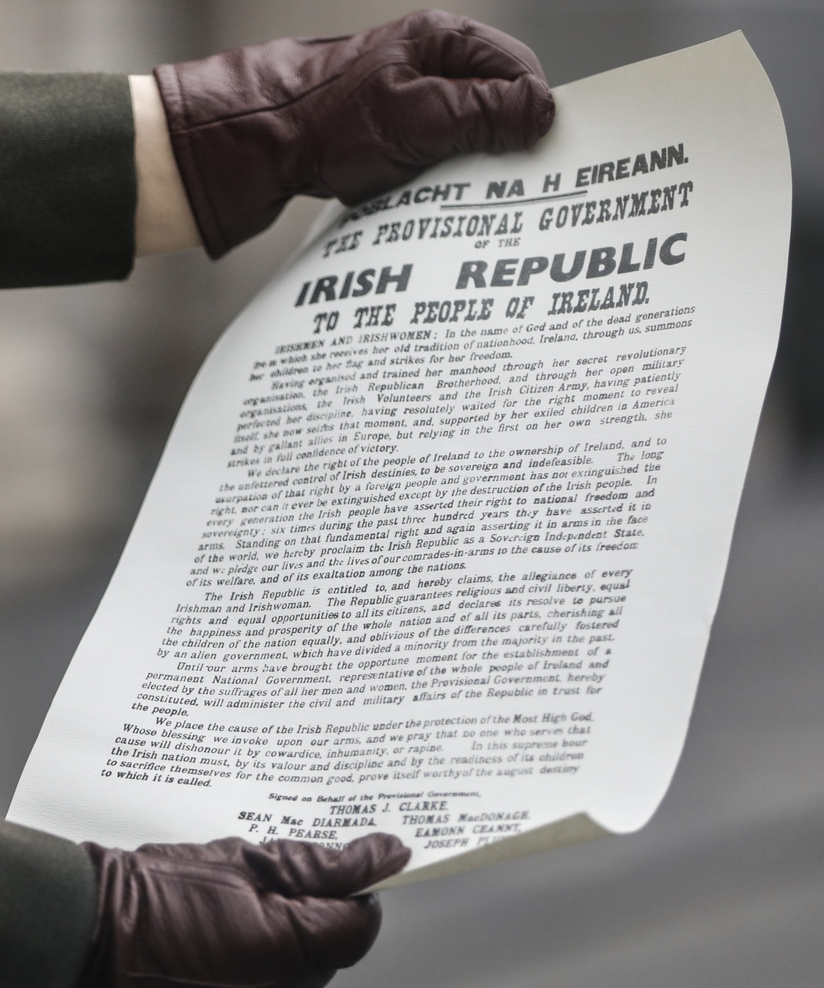 A member of the Defence Forces holding the Proclamation of Independence outside the GPO on O'Connell Street in Dublin for the 1916 commemoration