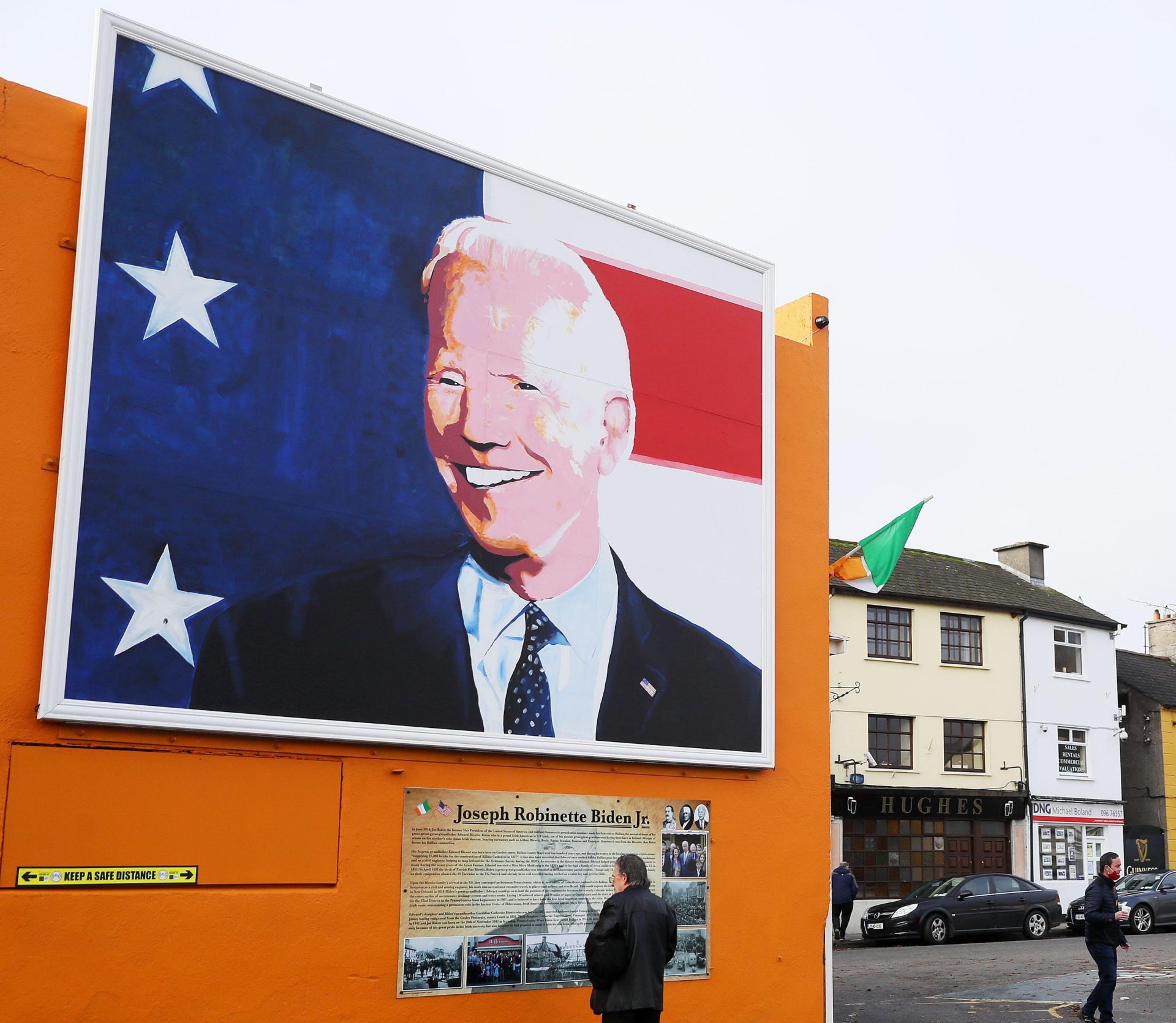 A man stops to read a plaque below a mural of Joe Biden in his ancestral home of Ballina, Co Mayo in November 2020.
