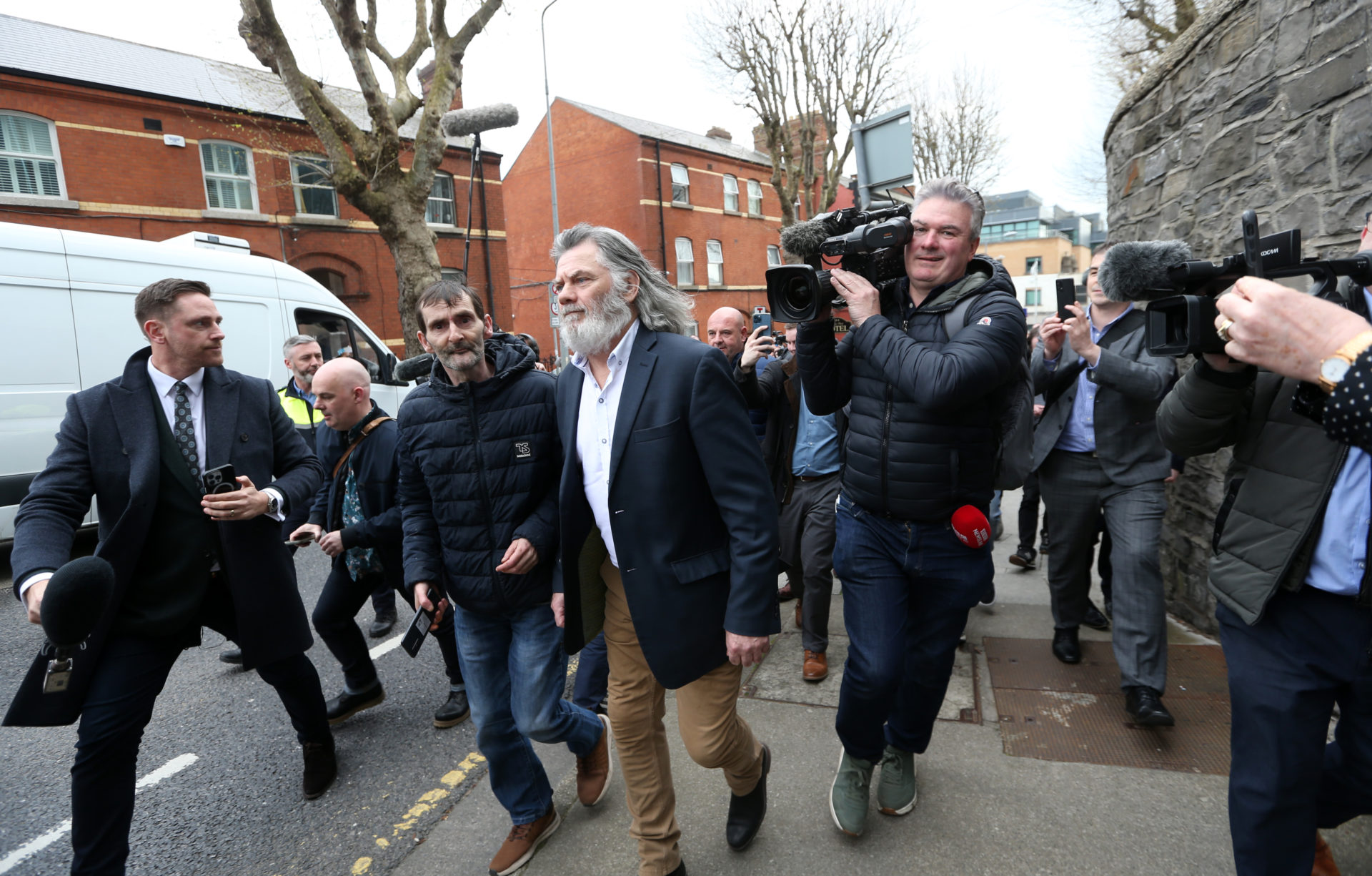 Gerry The Monk Hutch being followed by the media and reporters after being freed following his court case at the Criminal Courts, 18-04-2023. Image: Lazarov/RollingNews