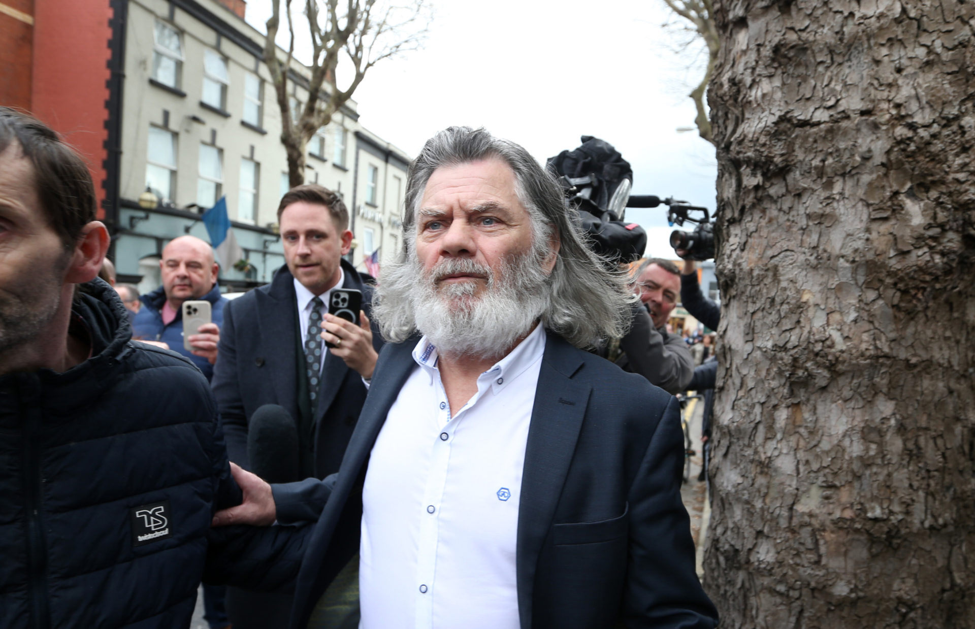 Gerry The Monk Hutch being followed by the media and reporters after being freed following his court case at the Criminal Courts