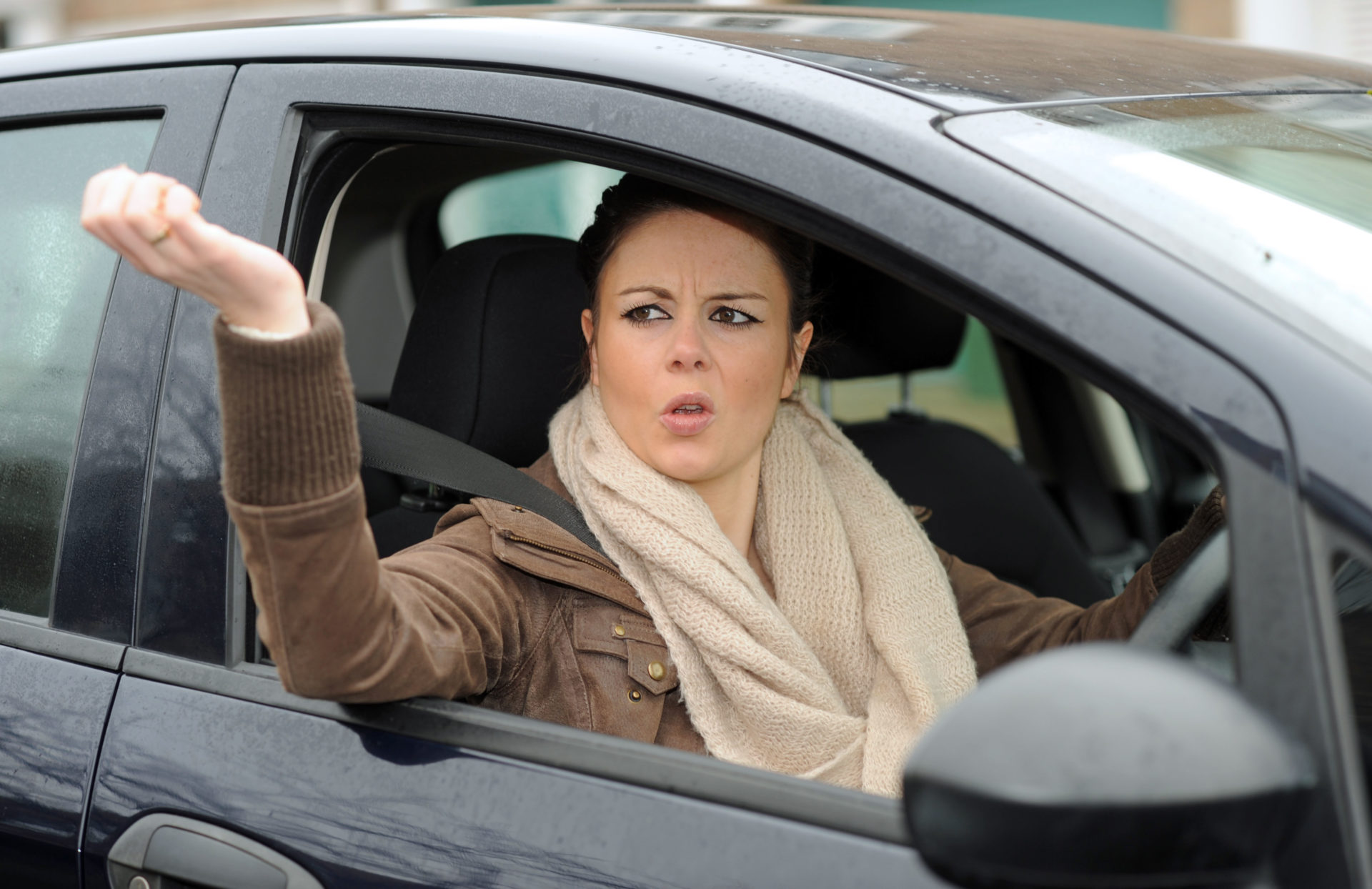 Female in her 20s angry driving a car with road rage shouting at other motorists (Simon Dack / Alamy Stock Photo)